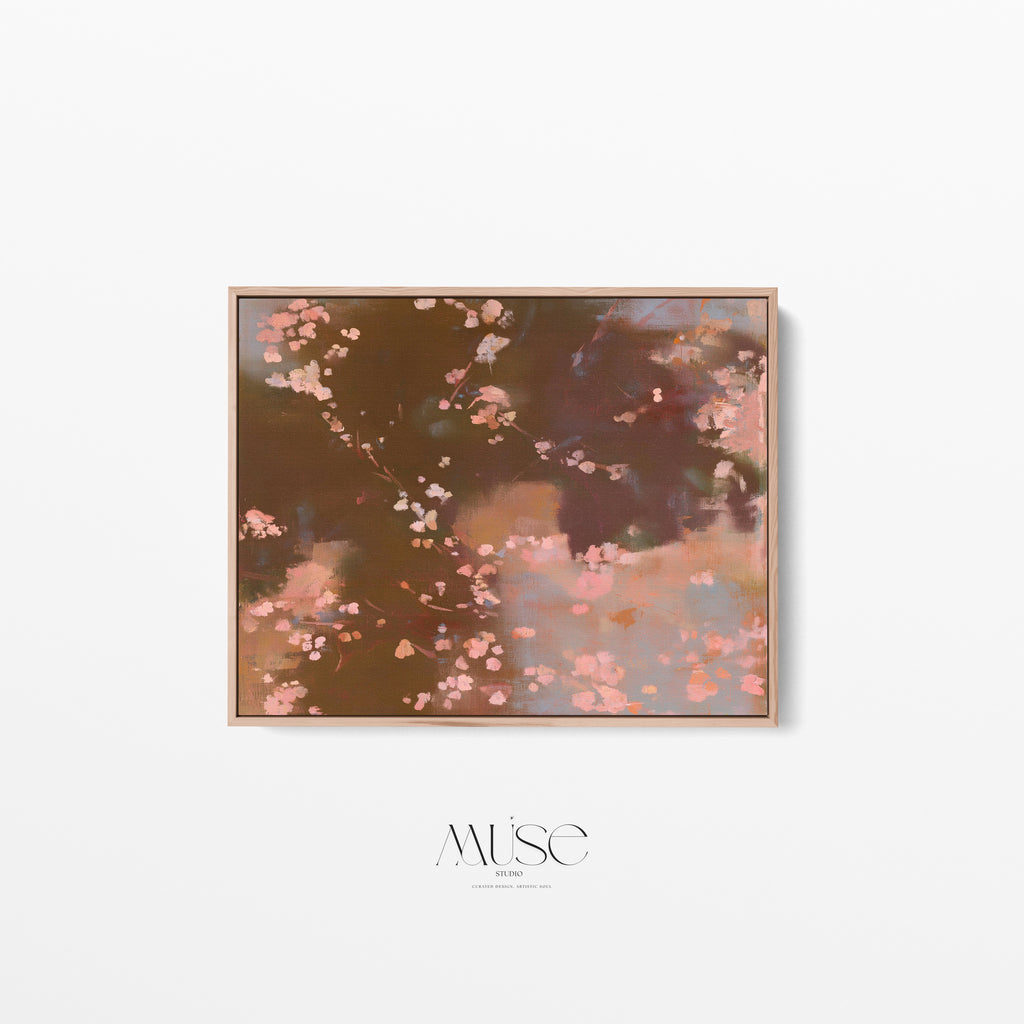 A framed abstract floral painting featuring pink blossoms on a dark brown and dusty rose background, displayed on a clean white wall with the brand name 'MUSE DESIGNS' printed below.
