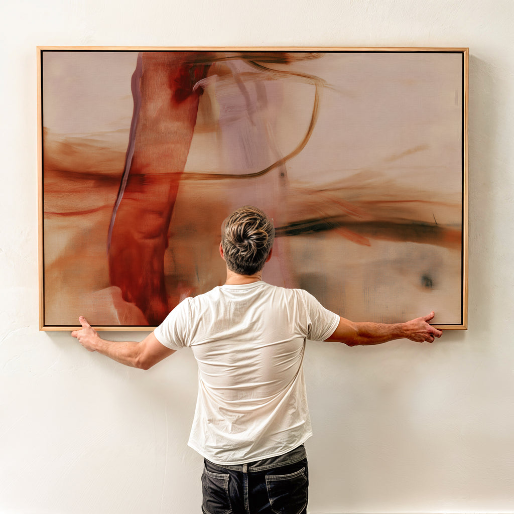 Person holding a large framed Quiet Passage No. 1161 abstract canvas against a light wall.