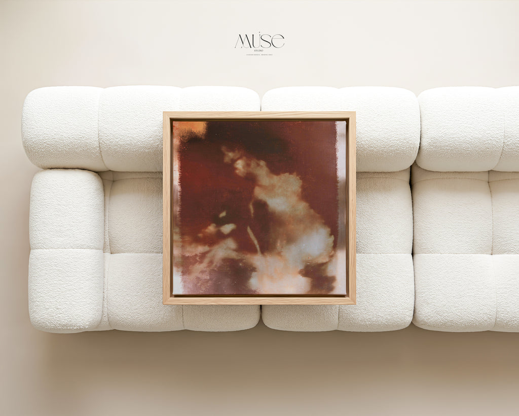Wild Aurelia No. 1172 framed abstract floral canvas displayed above a rust-colored sofa in a modern living room.