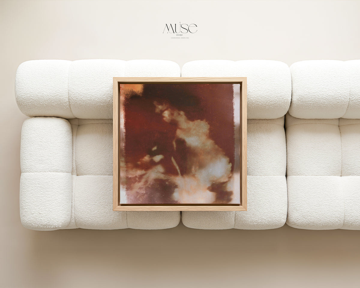 Wild Aurelia No. 1172 framed abstract floral canvas displayed above a rust-colored sofa in a modern living room.