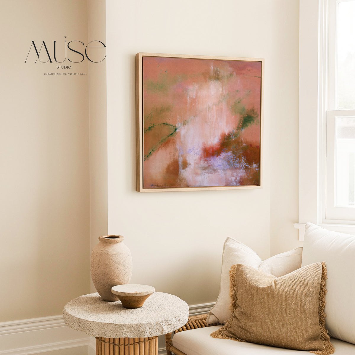 Framed square terracotta and peach canvas wall art mounted in a sunlit organic modern living space with a stone side table and ceramic vase.