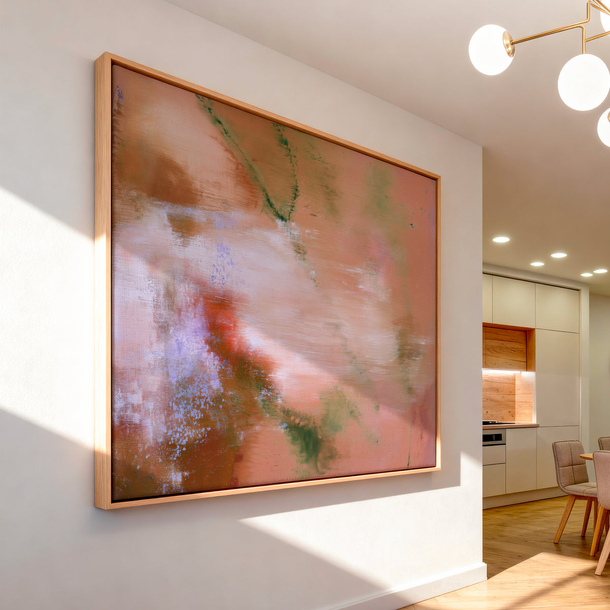 Large framed warm abstract wall art in light wood frame mounted in a modern sunlit dining room with soft interior lighting.