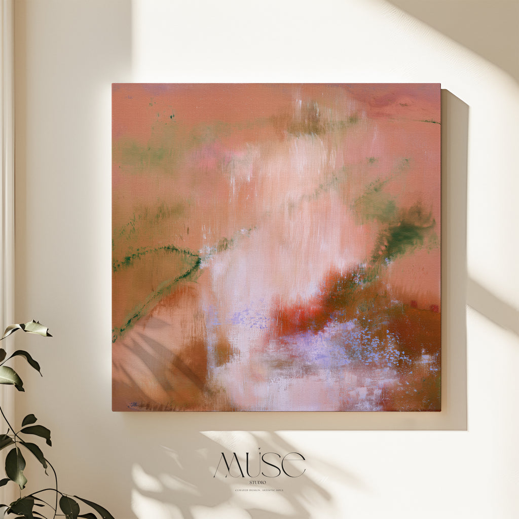 Square terracotta and peach abstract stretched canvas hanging on a warm beige plaster wall with soft botanical leaf shadows and houseplant foliage in the foreground.