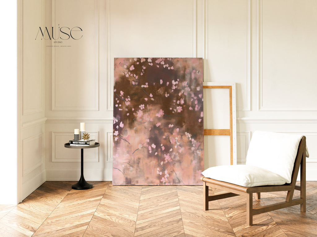 The Dawn Nocturne No. 1123 stretched canvas leans against a paneled wall next to a modern wooden lounge chair and a small round side table with decor in a minimalist loft space.