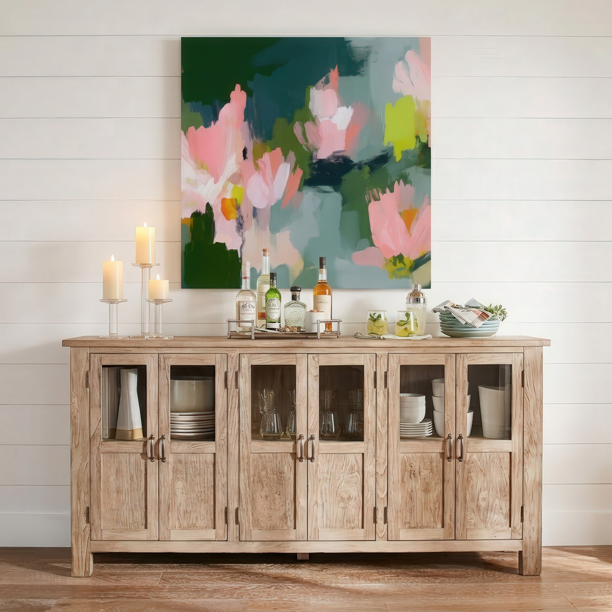 Garden Bloom No. 1039 canvas wall art displaying an organic, abstract floral design in shades of blush pink, vibrant chartreuse, and dark green, shown framed above a rustic wooden sideboard.
