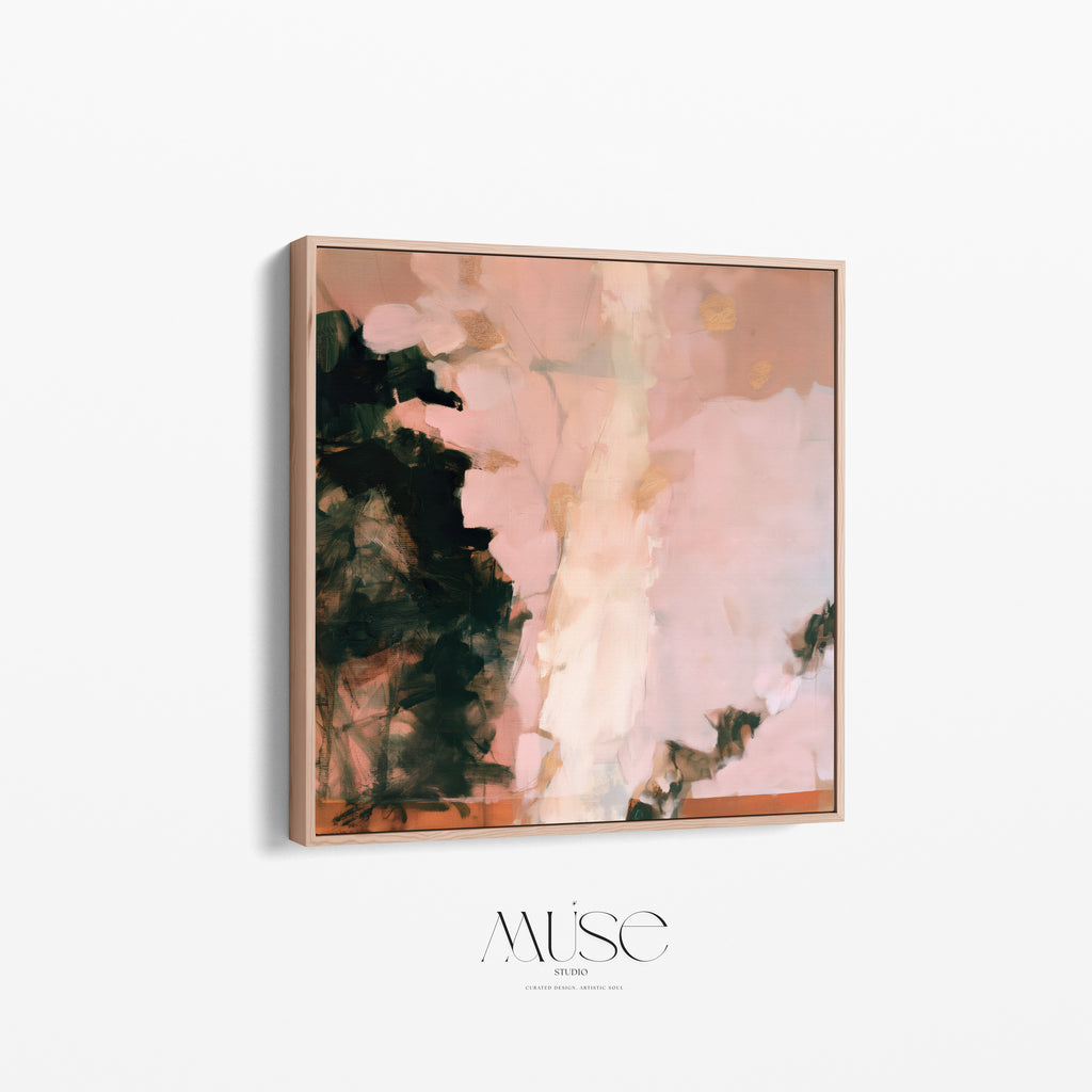 Angled perspective view of a square framed abstract painting print highlighting the depth of the natural oak frame and the textured blush pink and dark green canvas art.