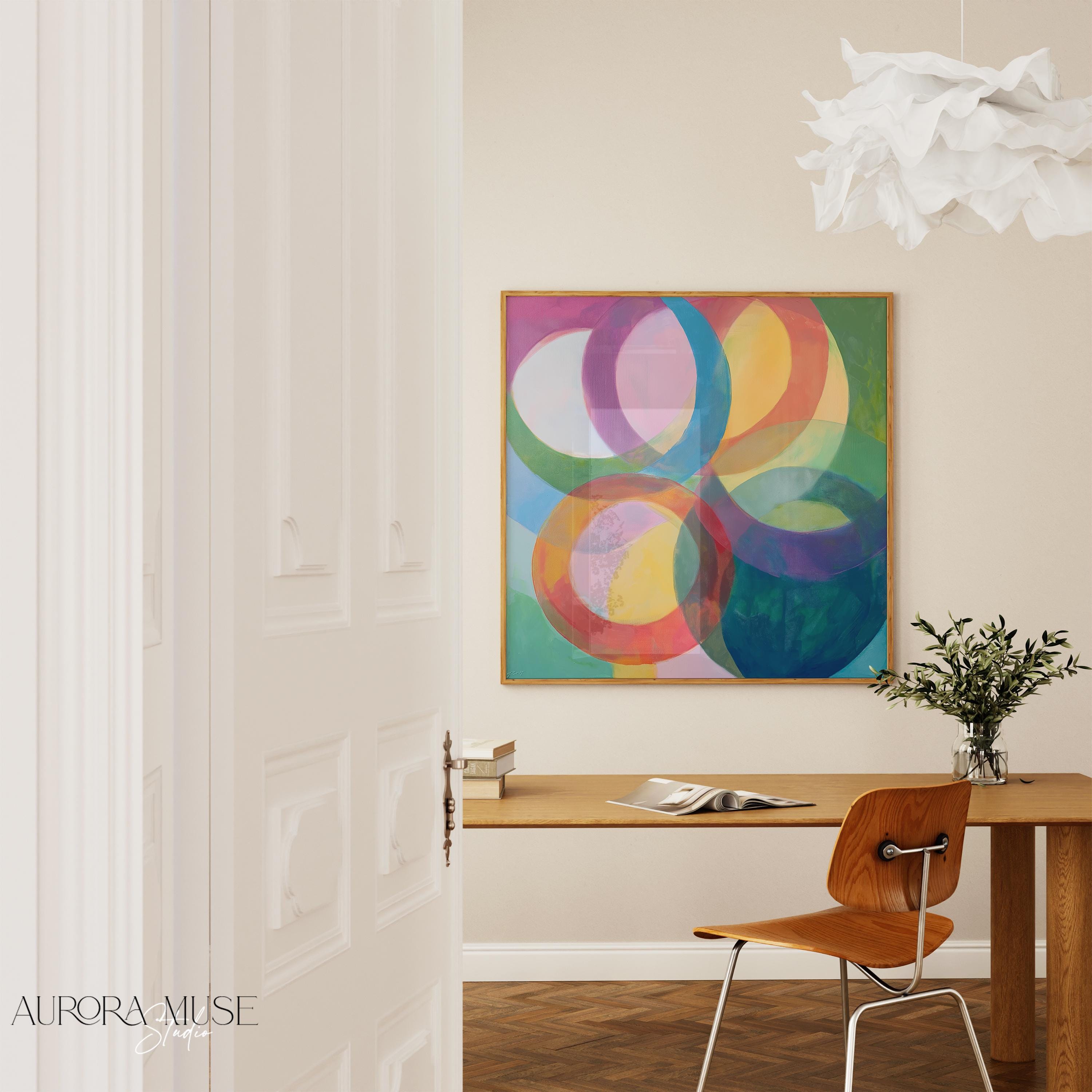Large square abstract wall art featuring bold pink and orange geometric circles in a retro-inspired composition, printed as large canvas wall art and styled in a modern home office to create a vibrant mid-century statement focal point.