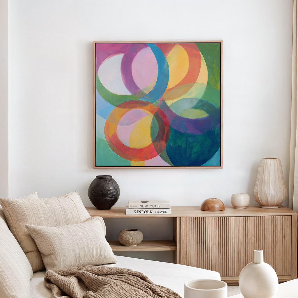 Large square abstract wall art featuring bold pink and orange geometric circles in a retro-inspired composition, printed as large canvas wall art and styled in a modern home office to create a vibrant mid-century statement focal point.