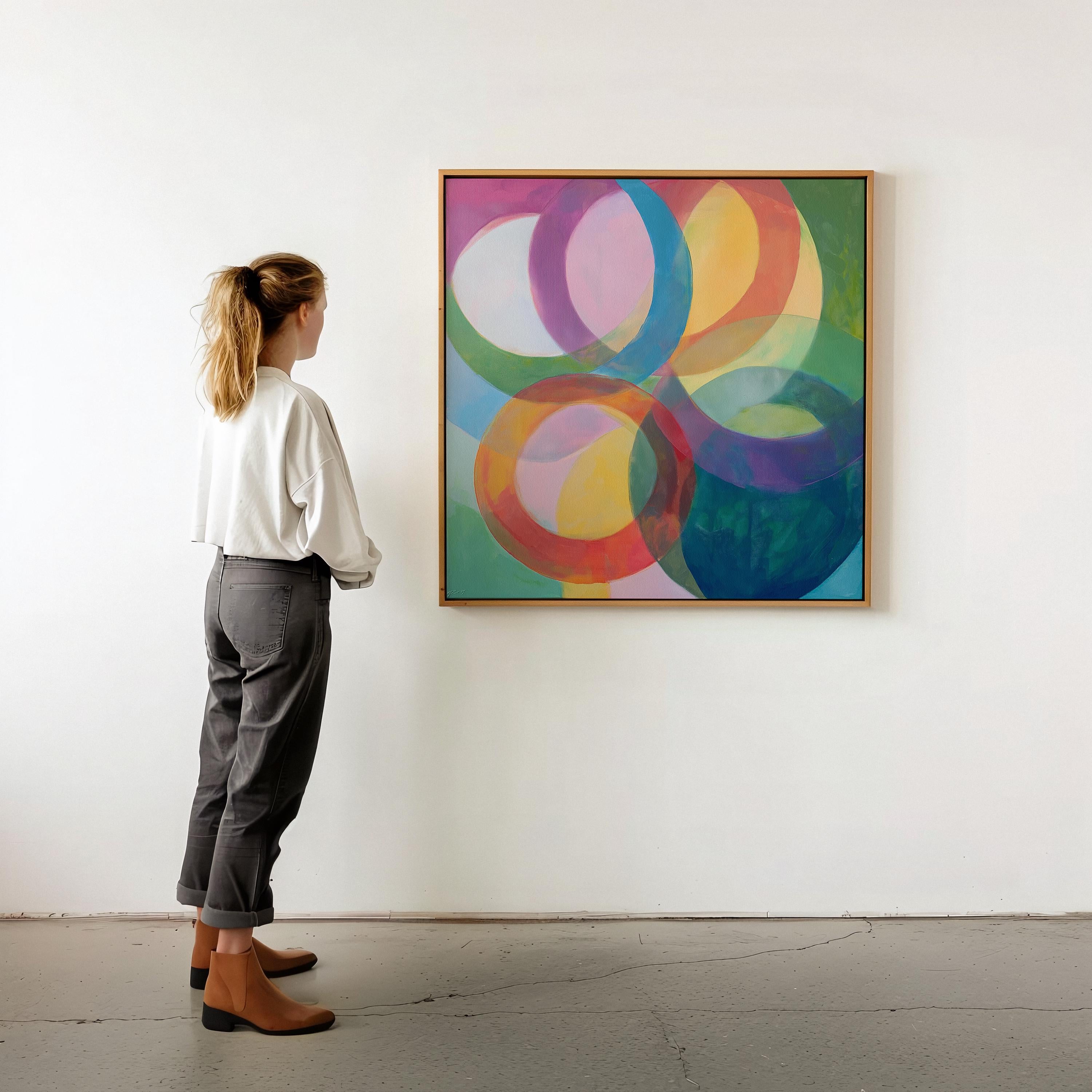 Large square abstract wall art featuring bold pink and orange geometric circles in a retro-inspired composition, printed as large canvas wall art and styled in a modern home office to create a vibrant mid-century statement focal point.