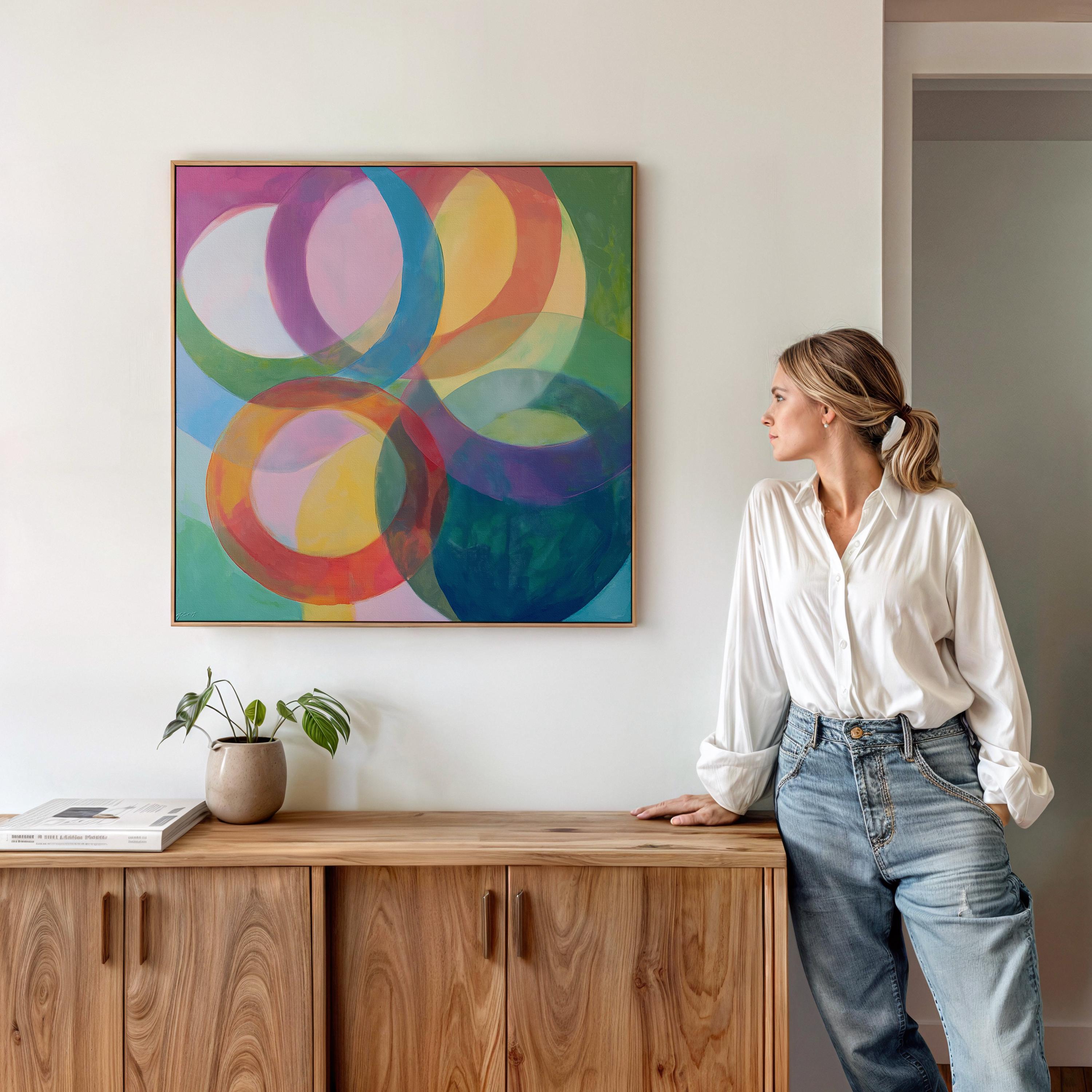Large square abstract wall art featuring bold pink and orange geometric circles in a retro-inspired composition, printed as large canvas wall art and styled in a modern home office to create a vibrant mid-century statement focal point.