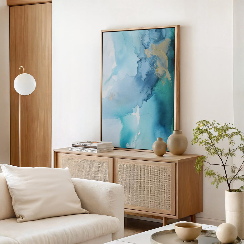 Coastal abstract canvas art by Muse Studio featuring blue, gold, and sandy neutral tones with fluid seaside-inspired movement. Premium gallery-wrapped cotton canvas printed with museum-grade giclée inks, styled for modern coastal living rooms, offices, bedrooms, and elevated neutral interiors.