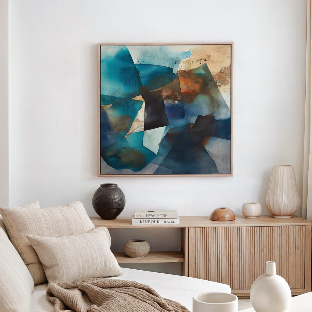 Square abstract wall art featuring deep teal, black, and rust tones leaning against a textured sunlit wall. Earthy modern framed canvas artwork with bold geometric movement, ideal for living room or designer interiors. Available as framed wall art or giclée canvas by Muse Studio.