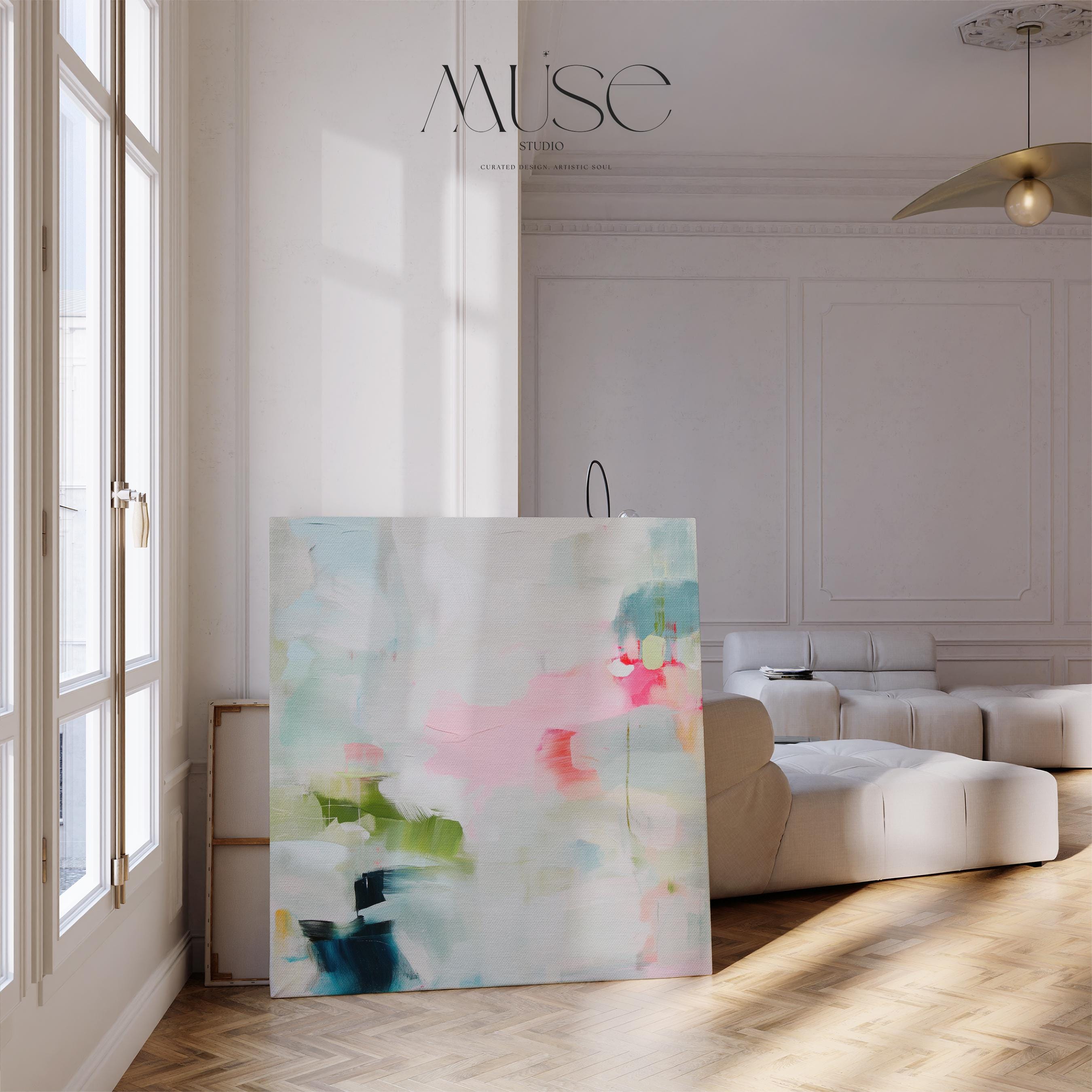 Framed abstract canvas wall art in blush pink, blue, green, and soft neutral tones. Square modern painting with expressive brushstrokes and light color palette. Ideal for bedrooms, home offices, or styled spaces seeking a feminine and fresh decor piece. Presented in a natural wood frame, this soft contemporary artwork adds gentle movement and colorful balance to curated interiors. A Muse Studio original designed for designer-led spaces.