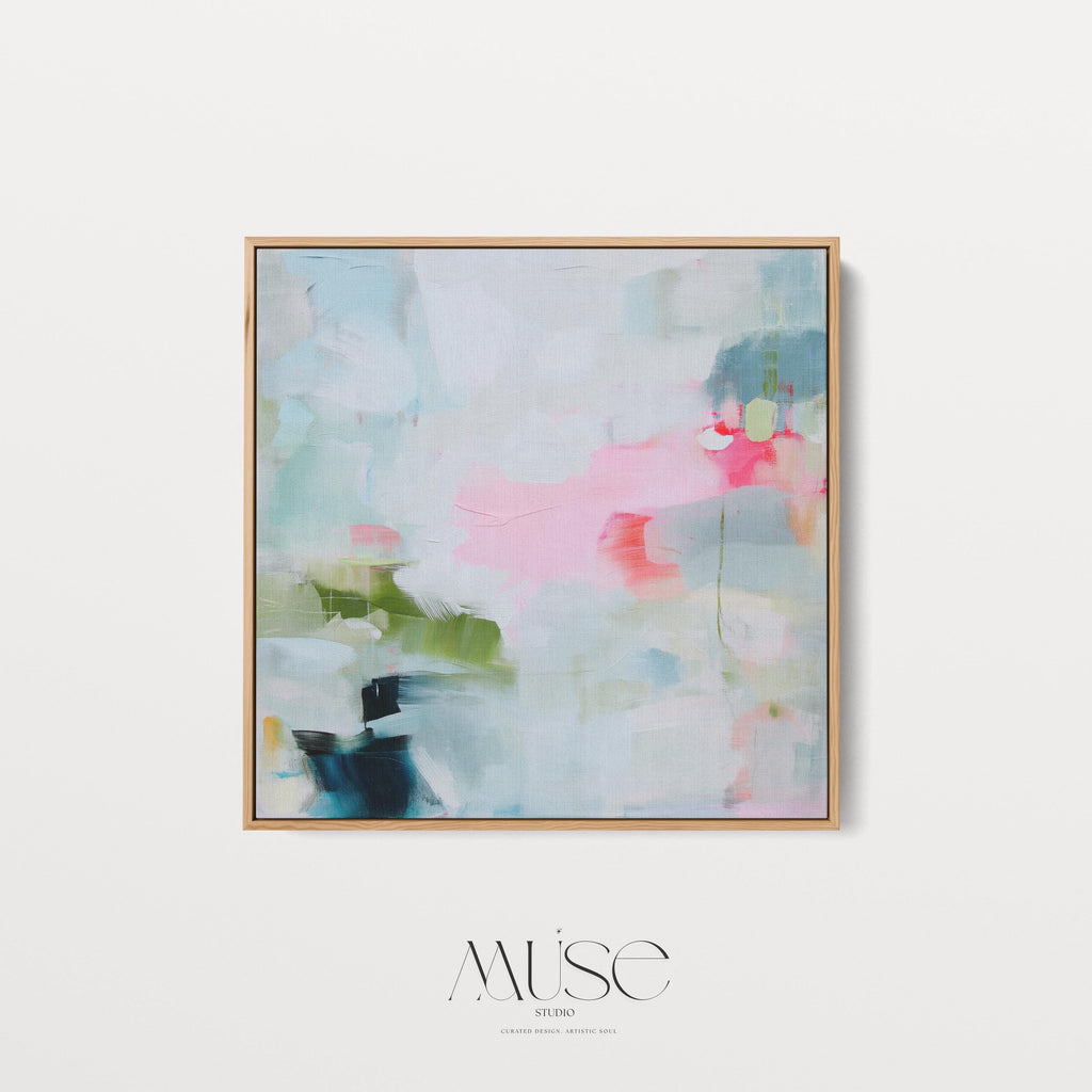 Framed abstract canvas wall art in blush pink, blue, green, and soft neutral tones. Square modern painting with expressive brushstrokes and light color palette. Ideal for bedrooms, home offices, or styled spaces seeking a feminine and fresh decor piece. Presented in a natural wood frame, this soft contemporary artwork adds gentle movement and colorful balance to curated interiors. A Muse Studio original designed for designer-led spaces.