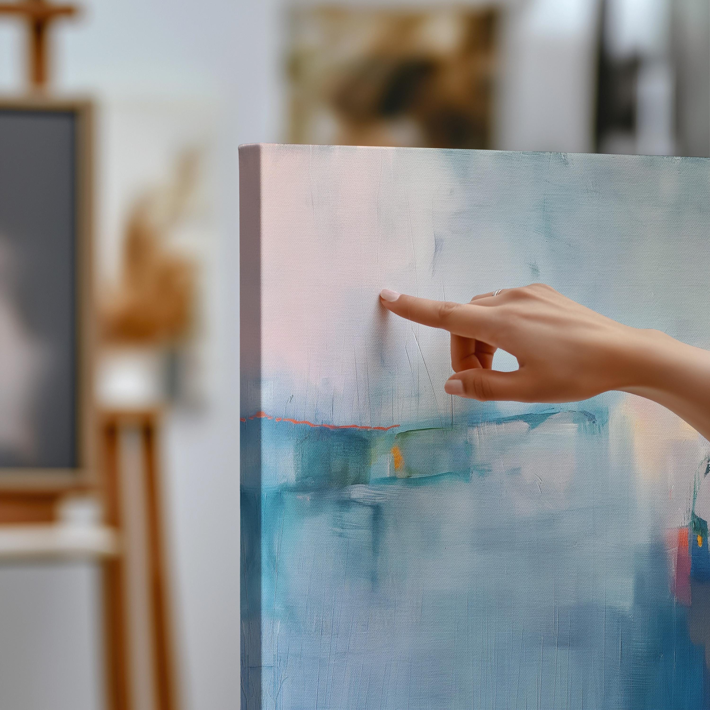 Square framed canvas wall art featuring a moody abstract landscape in rich blue, indigo, blush, and coral tones. This modern piece adds emotional depth and painterly texture to any room. Ideal for coastal interiors, minimalist spaces, or moody decor palettes. Framed in natural wood and displayed on a clean white wall, perfect for offices, living rooms, or curated art walls. Muse Studio original design for refined home styling.