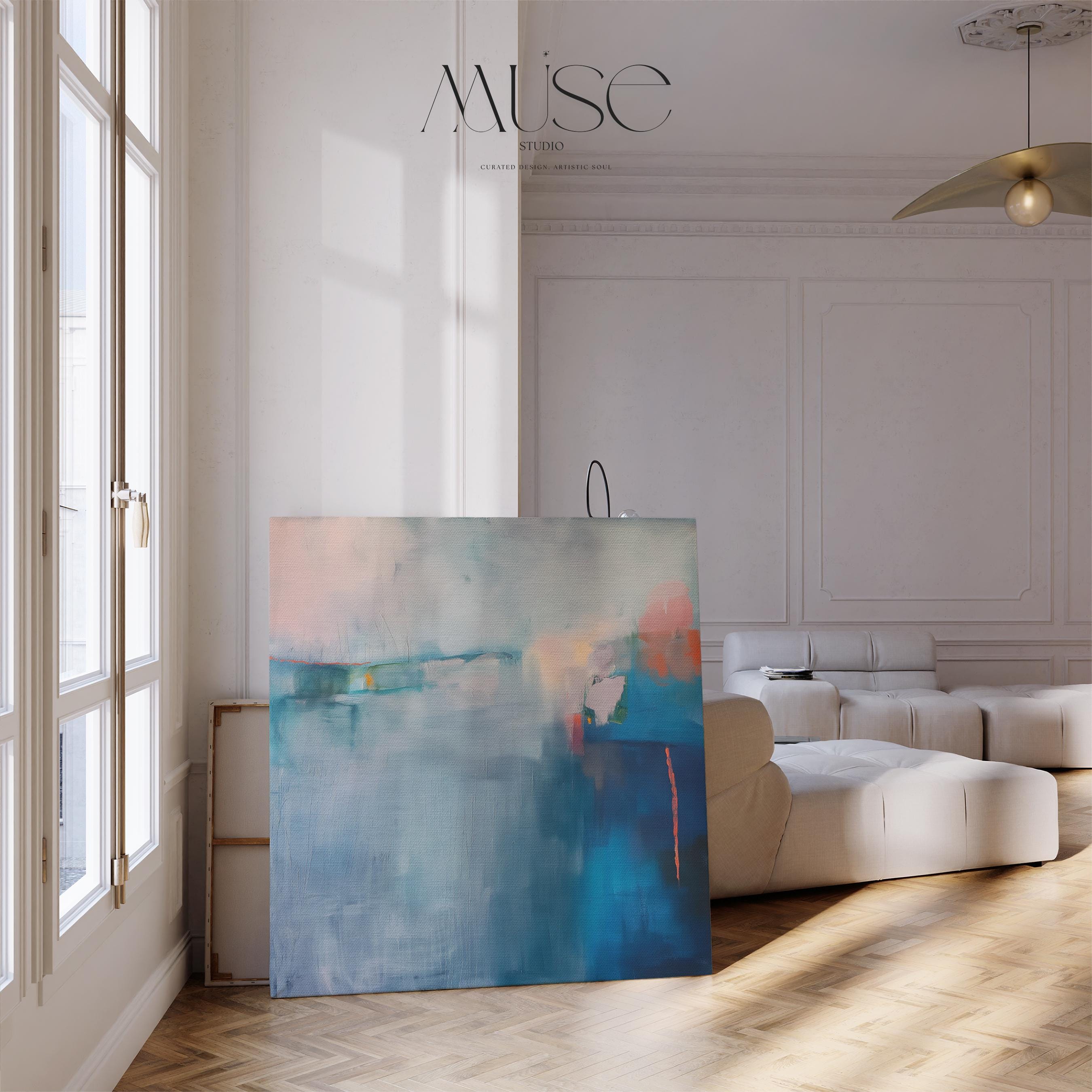 Square framed canvas wall art featuring a moody abstract landscape in rich blue, indigo, blush, and coral tones. This modern piece adds emotional depth and painterly texture to any room. Ideal for coastal interiors, minimalist spaces, or moody decor palettes. Framed in natural wood and displayed on a clean white wall, perfect for offices, living rooms, or curated art walls. Muse Studio original design for refined home styling.