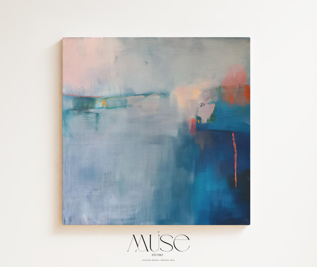 Square framed canvas wall art featuring a moody abstract landscape in rich blue, indigo, blush, and coral tones. This modern piece adds emotional depth and painterly texture to any room. Ideal for coastal interiors, minimalist spaces, or moody decor palettes. Framed in natural wood and displayed on a clean white wall, perfect for offices, living rooms, or curated art walls. Muse Studio original design for refined home styling.