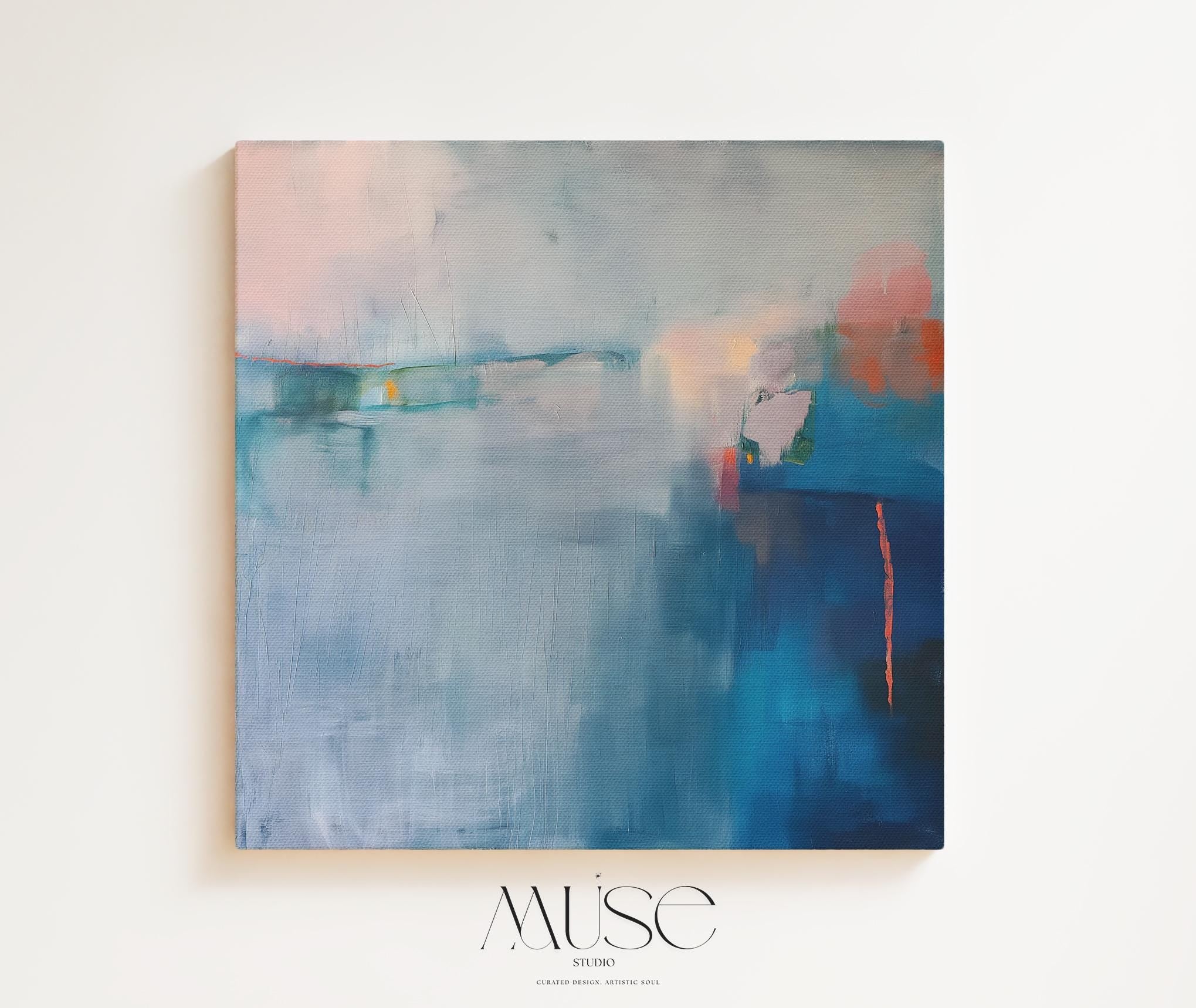 Square framed canvas wall art featuring a moody abstract landscape in rich blue, indigo, blush, and coral tones. This modern piece adds emotional depth and painterly texture to any room. Ideal for coastal interiors, minimalist spaces, or moody decor palettes. Framed in natural wood and displayed on a clean white wall, perfect for offices, living rooms, or curated art walls. Muse Studio original design for refined home styling.