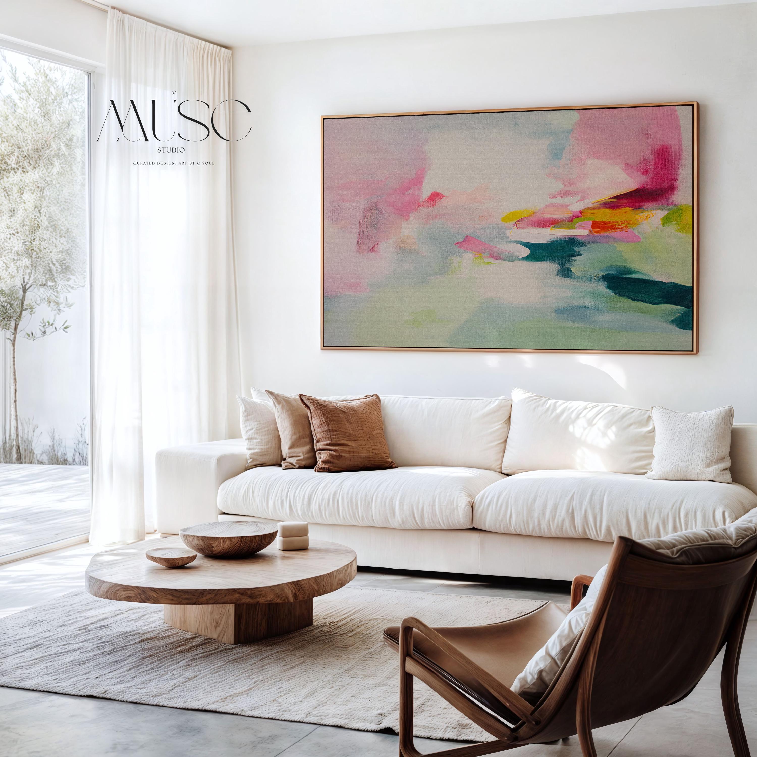 Framed canvas wall art featuring a soft abstract composition in blush pink, teal, lemon yellow, and mint green. The painting blends gentle brushstrokes and airy movement, creating a serene and modern feel. Styled in a sunlit room with warm wood tones, neutral decor, and minimalist furnishings. Perfect for bedrooms, living rooms, or contemporary interiors. Muse Studio artwork designed for curated home decor with a soft contemporary aesthetic.