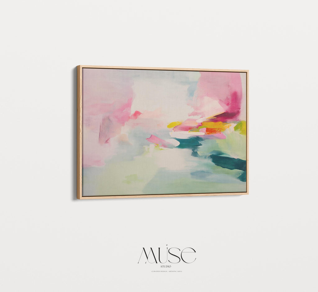 Framed canvas wall art featuring a soft abstract composition in blush pink, teal, lemon yellow, and mint green. The painting blends gentle brushstrokes and airy movement, creating a serene and modern feel. Styled in a sunlit room with warm wood tones, neutral decor, and minimalist furnishings. Perfect for bedrooms, living rooms, or contemporary interiors. Muse Studio artwork designed for curated home decor with a soft contemporary aesthetic.