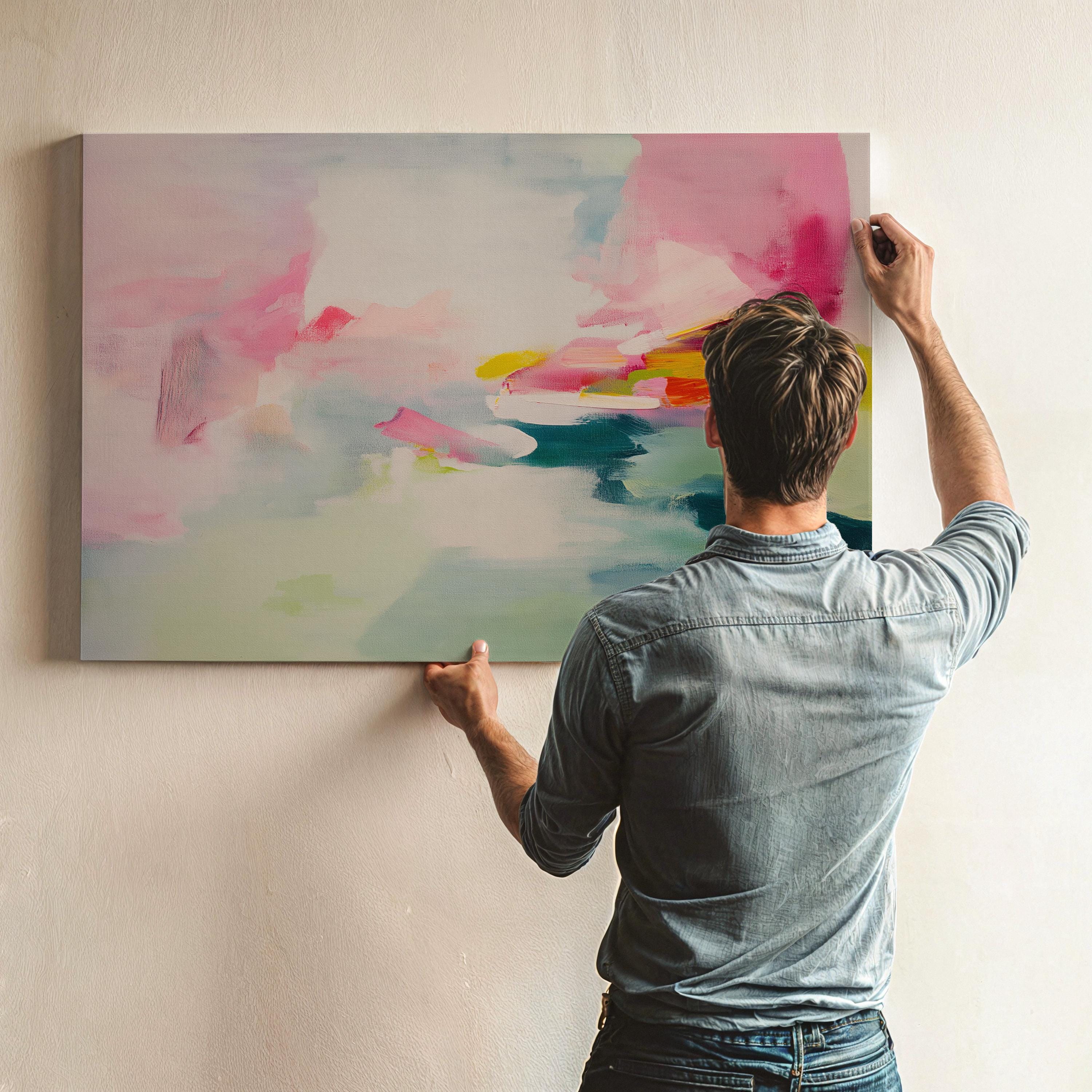 Large abstract canvas wall art with soft contemporary styling in blush pink, seafoam green, and vibrant accents of teal, yellow, and fuchsia. The airy brushwork evokes a dreamy horizon, perfect for serene yet colorful interiors. Shown unframed and mounted in a modern room with warm light and minimalist styling. Ideal for living rooms, bedrooms, or design-forward spaces. From Muse Studio – curated boutique decor art styled for life.