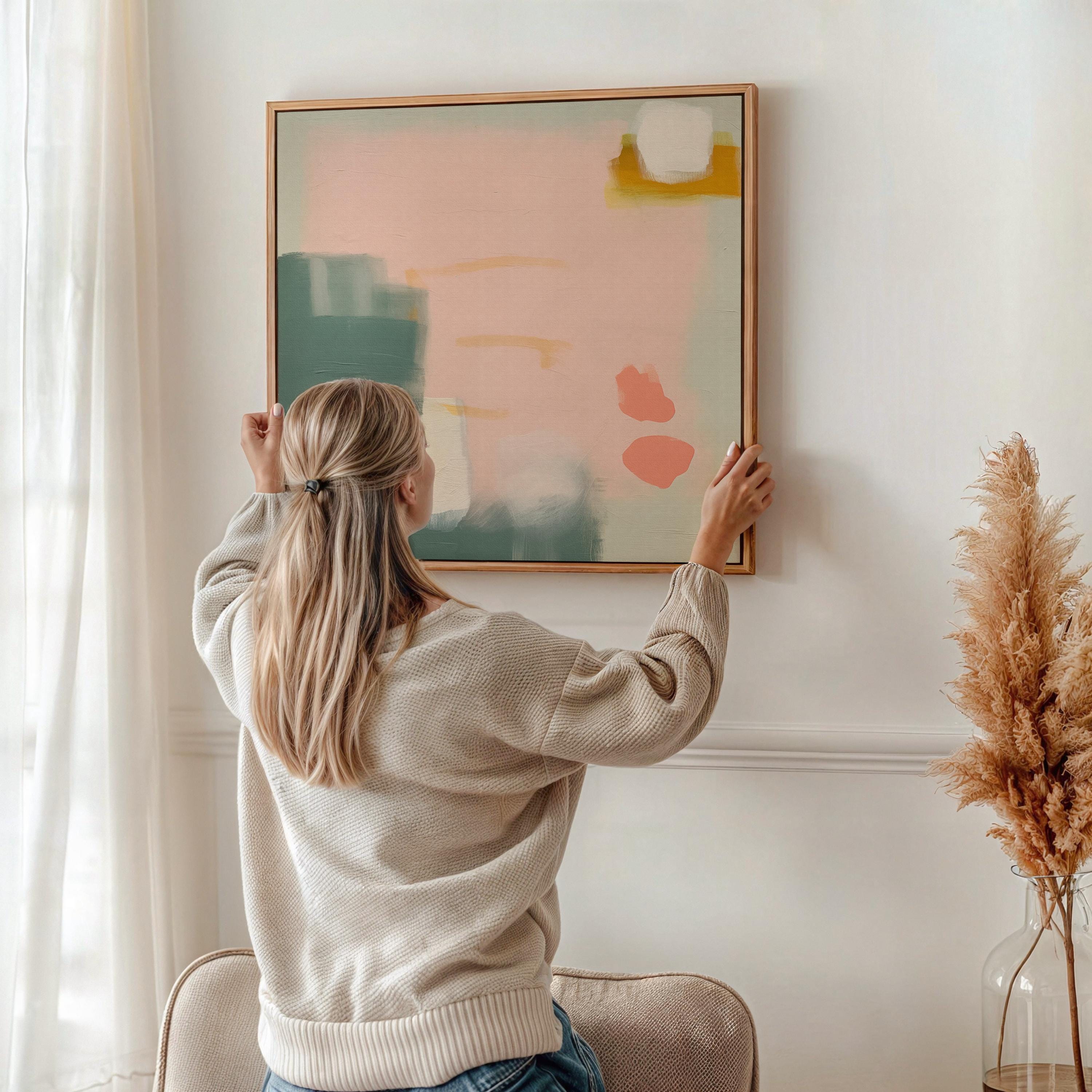 Square warm minimalist abstract wall art featuring blush pink, muted green, soft white, and clay orange tones in a calm, balanced layout. Designed for muted modern decor in bedrooms, entryways, or transitional interiors. Available as a fine art poster or canvas wall art for curated, color-forward decor.