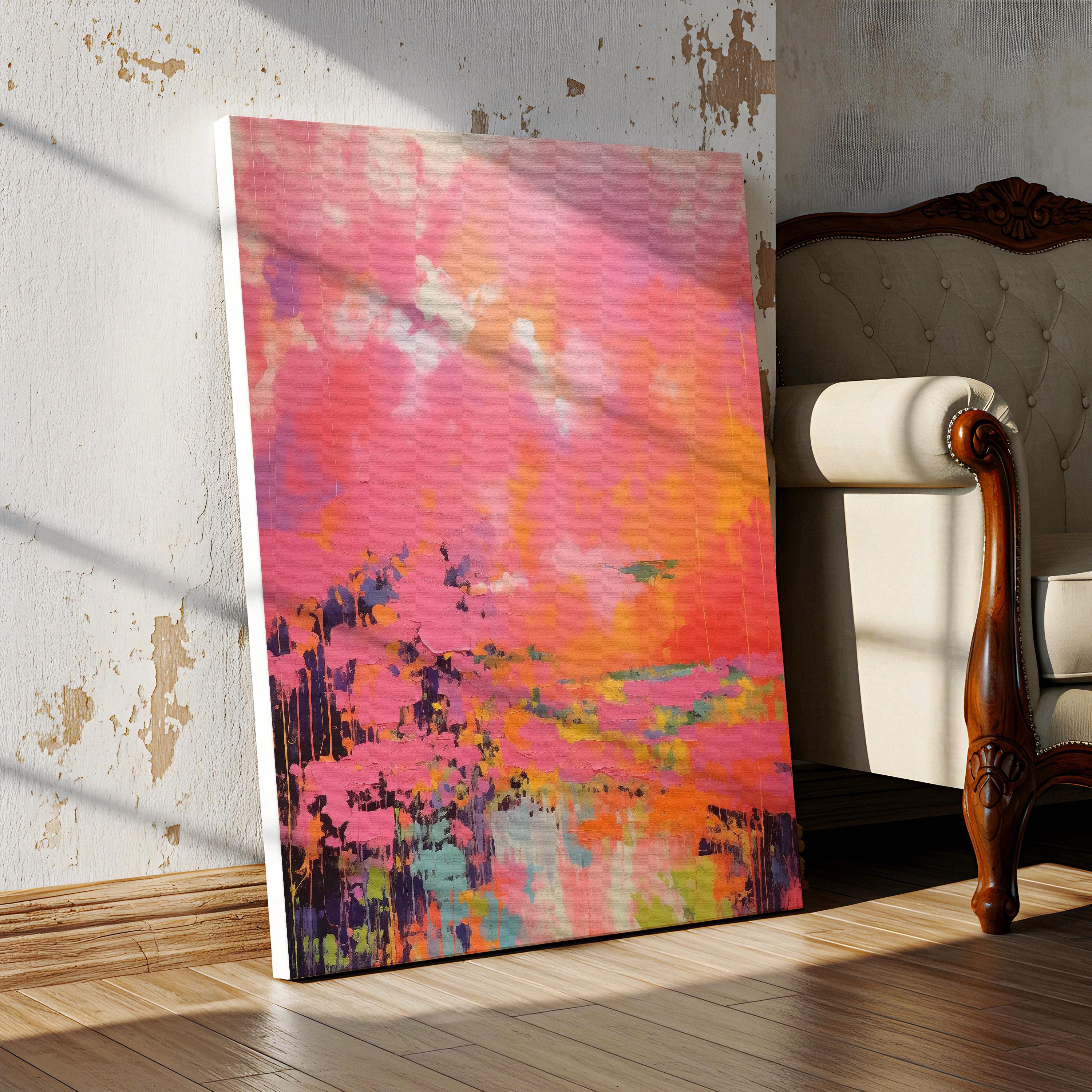 Vertical canvas wall art featuring bold sunset hues of pink, orange, coral, and lavender in a dreamy abstract landscape. Painted in expressive brushwork with glowing color fields, this piece blends beautifully with transitional or boho decor in bedrooms, entryways, or modern curated spaces. Available as a fine art poster or canvas wall art for curated, color-forward decor.