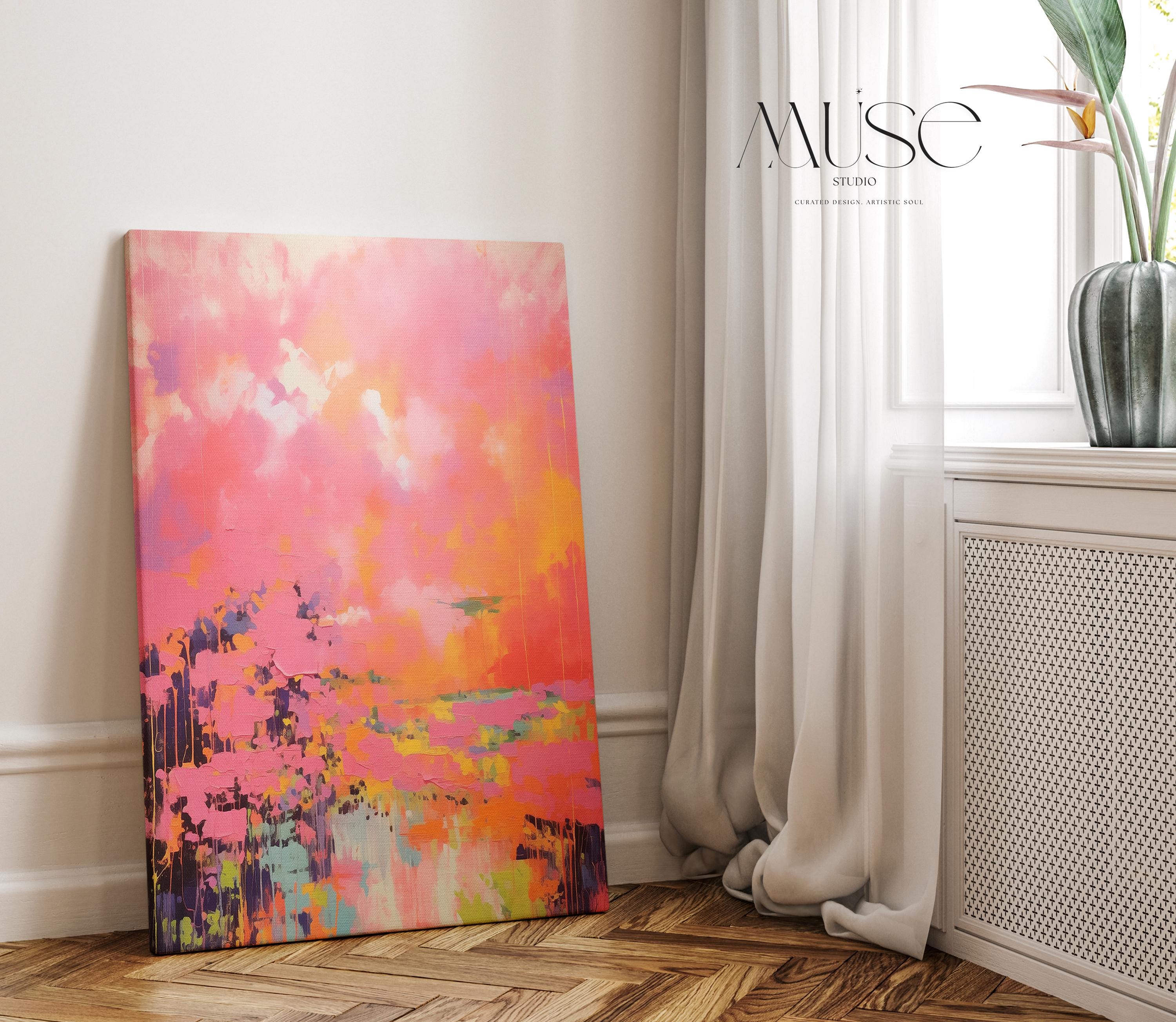 Vertical canvas wall art featuring bold sunset hues of pink, orange, coral, and lavender in a dreamy abstract landscape. Painted in expressive brushwork with glowing color fields, this piece blends beautifully with transitional or boho decor in bedrooms, entryways, or modern curated spaces. Available as a fine art poster or canvas wall art for curated, color-forward decor.