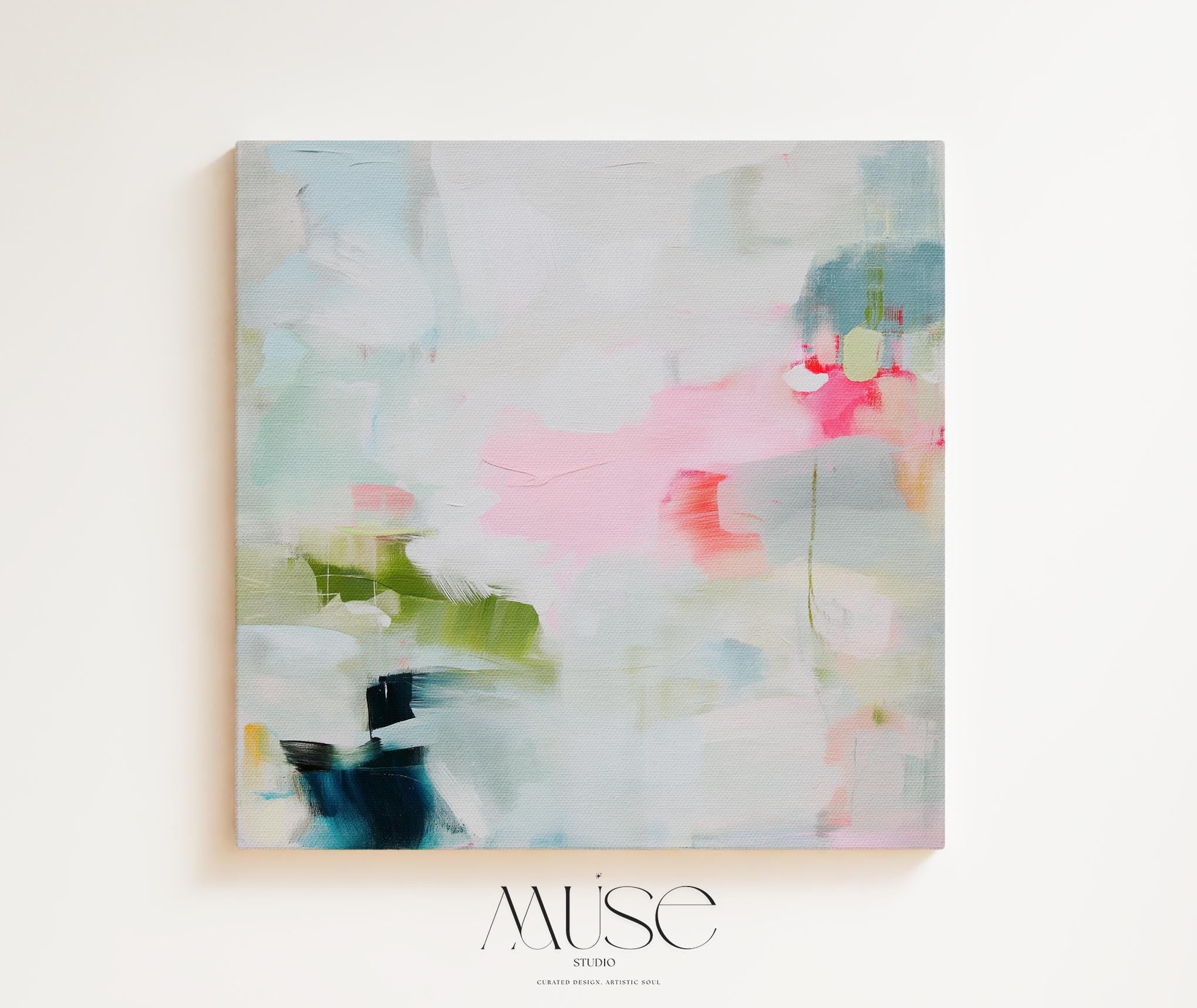 Framed abstract canvas wall art in blush pink, blue, green, and soft neutral tones. Square modern painting with expressive brushstrokes and light color palette. Ideal for bedrooms, home offices, or styled spaces seeking a feminine and fresh decor piece. Presented in a natural wood frame, this soft contemporary artwork adds gentle movement and colorful balance to curated interiors. A Muse Studio original designed for designer-led spaces.