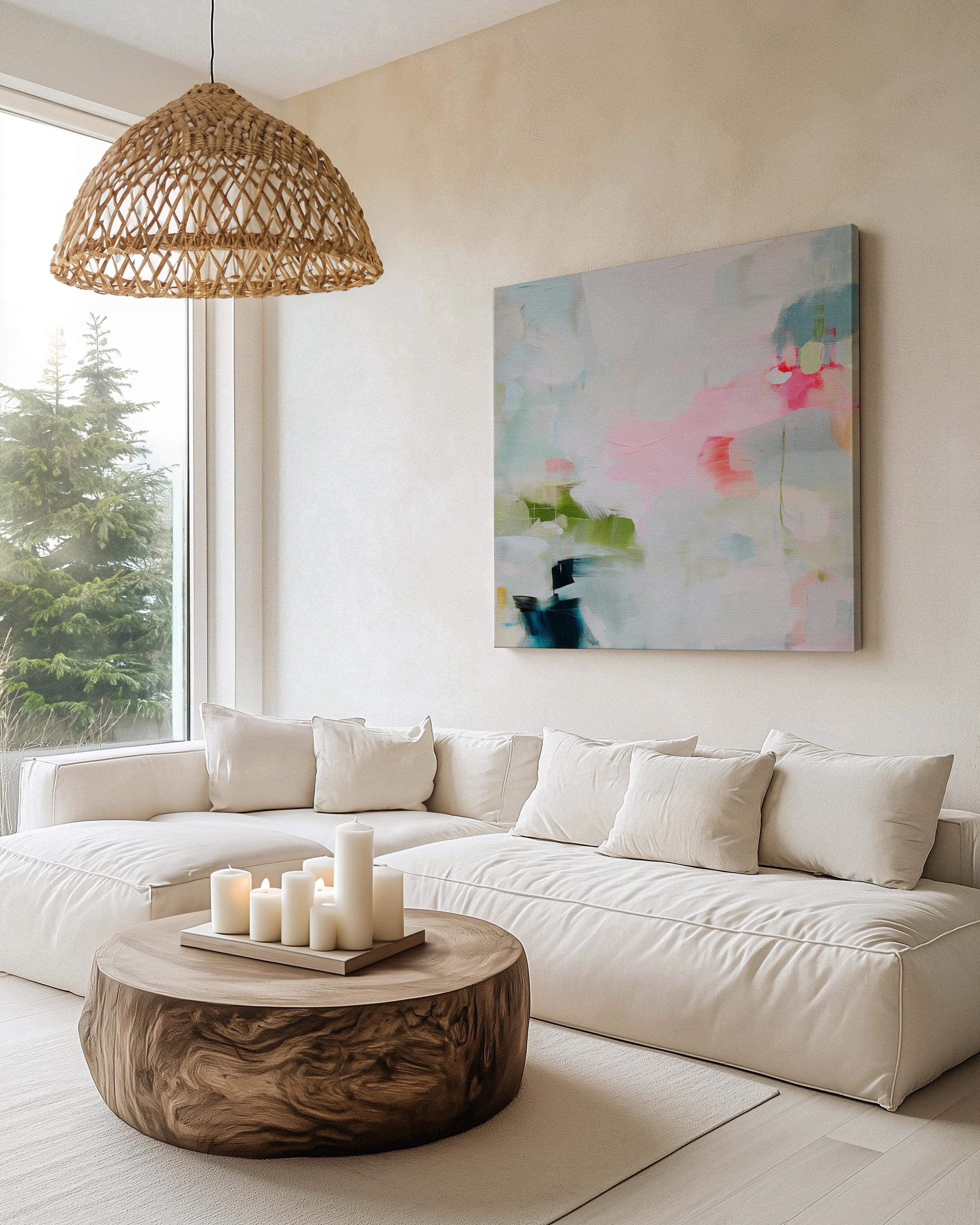 Framed abstract canvas wall art in blush pink, blue, green, and soft neutral tones. Square modern painting with expressive brushstrokes and light color palette. Ideal for bedrooms, home offices, or styled spaces seeking a feminine and fresh decor piece. Presented in a natural wood frame, this soft contemporary artwork adds gentle movement and colorful balance to curated interiors. A Muse Studio original designed for designer-led spaces.