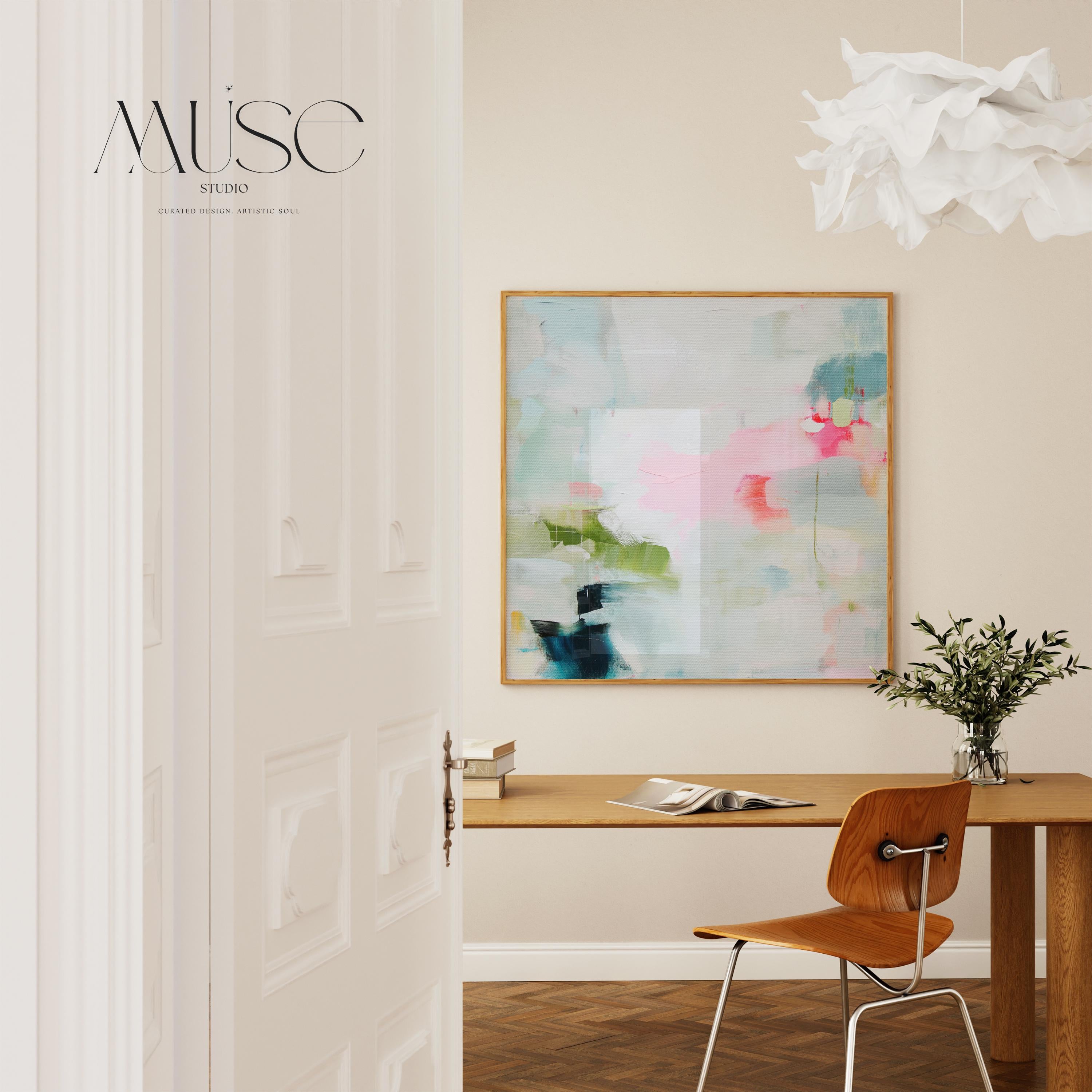 Framed abstract canvas wall art in blush pink, blue, green, and soft neutral tones. Square modern painting with expressive brushstrokes and light color palette. Ideal for bedrooms, home offices, or styled spaces seeking a feminine and fresh decor piece. Presented in a natural wood frame, this soft contemporary artwork adds gentle movement and colorful balance to curated interiors. A Muse Studio original designed for designer-led spaces.