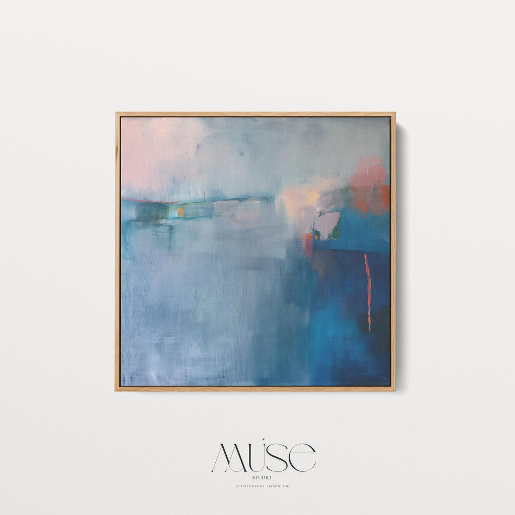 Square framed canvas wall art featuring a moody abstract landscape in rich blue, indigo, blush, and coral tones. This modern piece adds emotional depth and painterly texture to any room. Ideal for coastal interiors, minimalist spaces, or moody decor palettes. Framed in natural wood and displayed on a clean white wall, perfect for offices, living rooms, or curated art walls. Muse Studio original design for refined home styling.