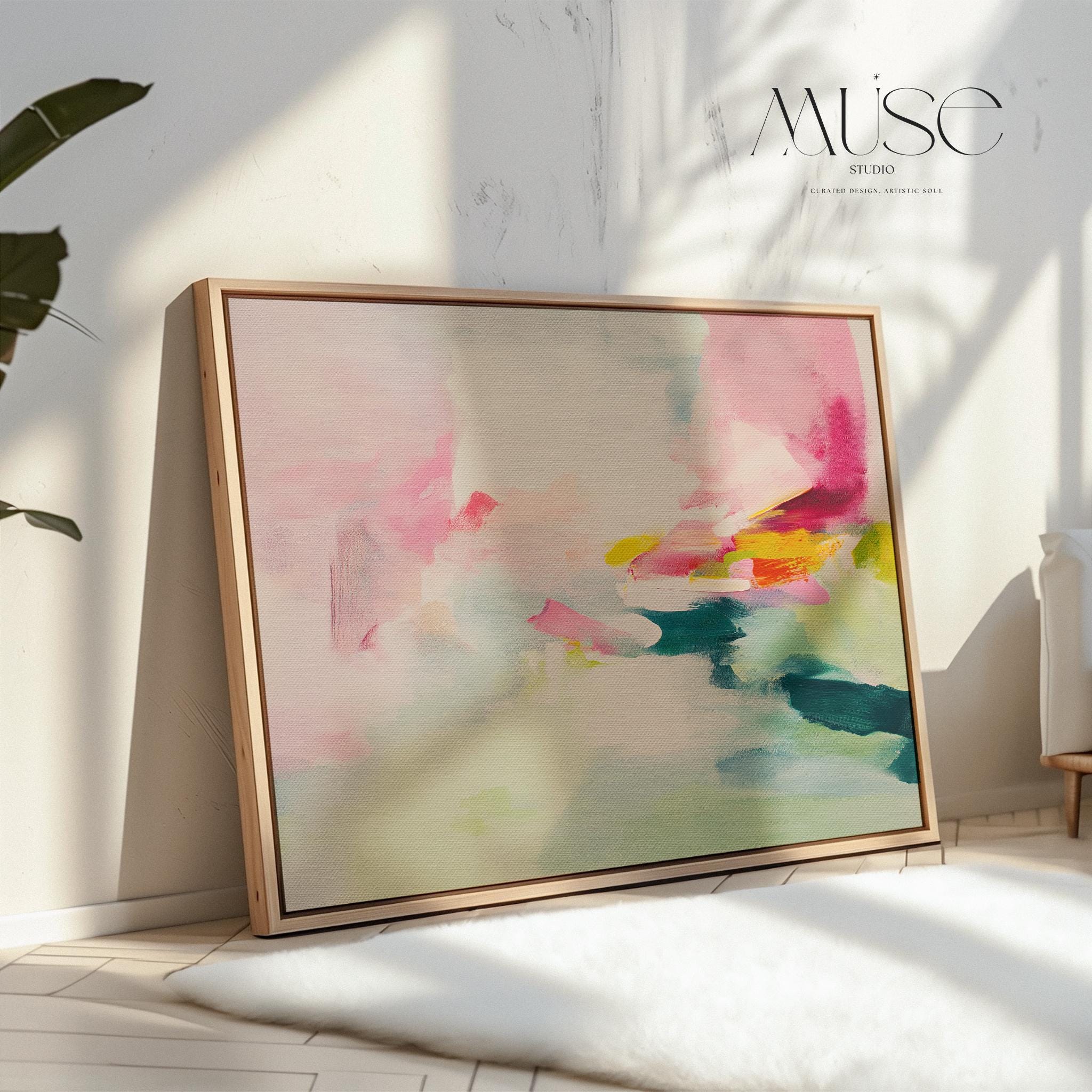 Framed canvas wall art featuring a soft abstract composition in blush pink, teal, lemon yellow, and mint green. The painting blends gentle brushstrokes and airy movement, creating a serene and modern feel. Styled in a sunlit room with warm wood tones, neutral decor, and minimalist furnishings. Perfect for bedrooms, living rooms, or contemporary interiors. Muse Studio artwork designed for curated home decor with a soft contemporary aesthetic.