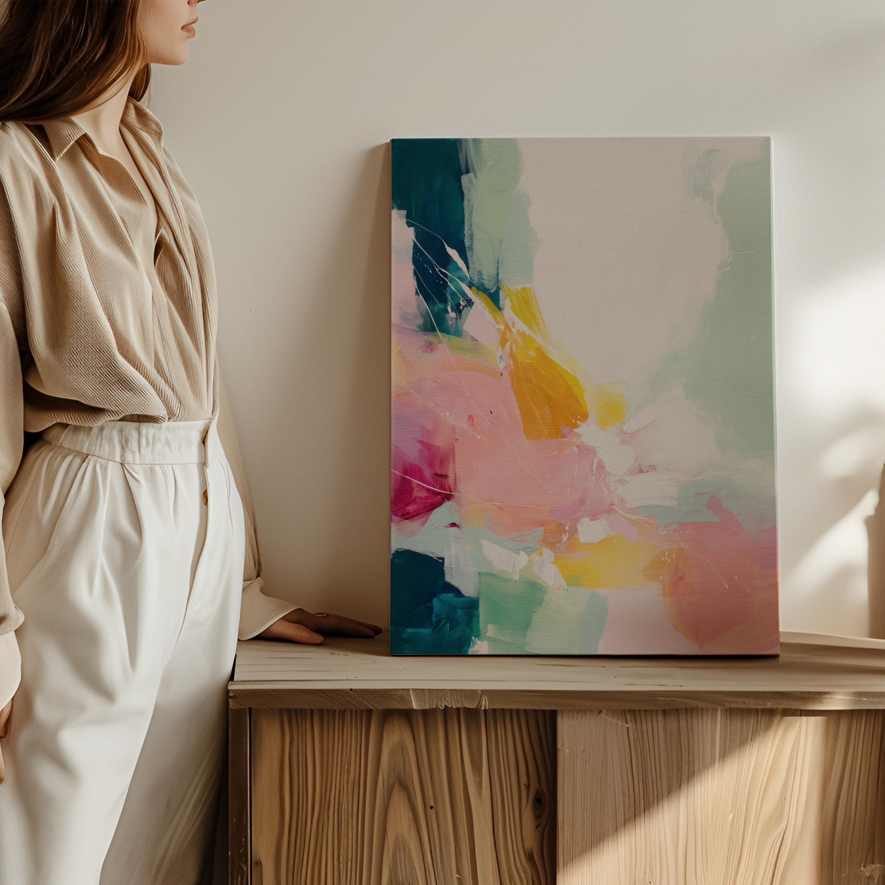 Vertical abstract wall art with soft contemporary styling, featuring bold strokes of pink, coral, teal, yellow, and soft mint green. The vibrant yet airy composition is printed on a high-quality canvas, displayed against a clean white wall in natural light. This color pop artwork from Muse Studio brings energetic movement and a modern touch to curated interiors, perfect for bedrooms, entryways, or stylish living spaces.