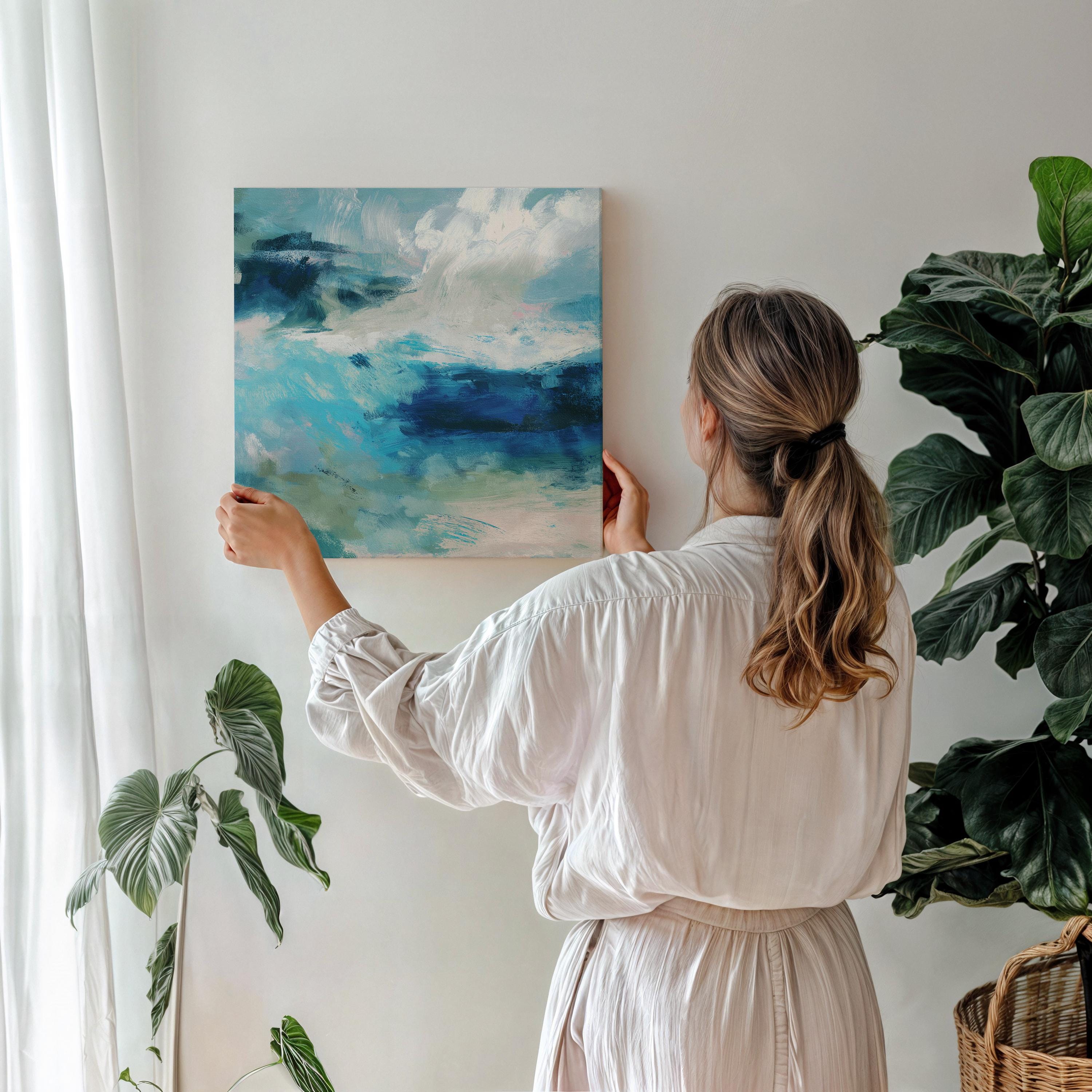 Abstract coastal wall art featuring ocean-inspired blues, sage green, and soft white brushstrokes. The textured seascape blends horizon and water with expressive movement, perfect for beach house decor, living rooms, or serene interiors. Available as a fine art poster or canvas wall art for curated, color-forward decor.