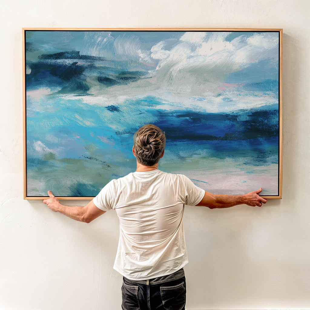 Framed horizontal canvas wall art featuring a coastal abstract with soft blue, sage green, and navy brushstrokes. Designed in a calming, fluid style ideal for beach house interiors, coastal living rooms, or nature-inspired decor. Available as a fine art poster or canvas wall art for curated, color-forward decor.