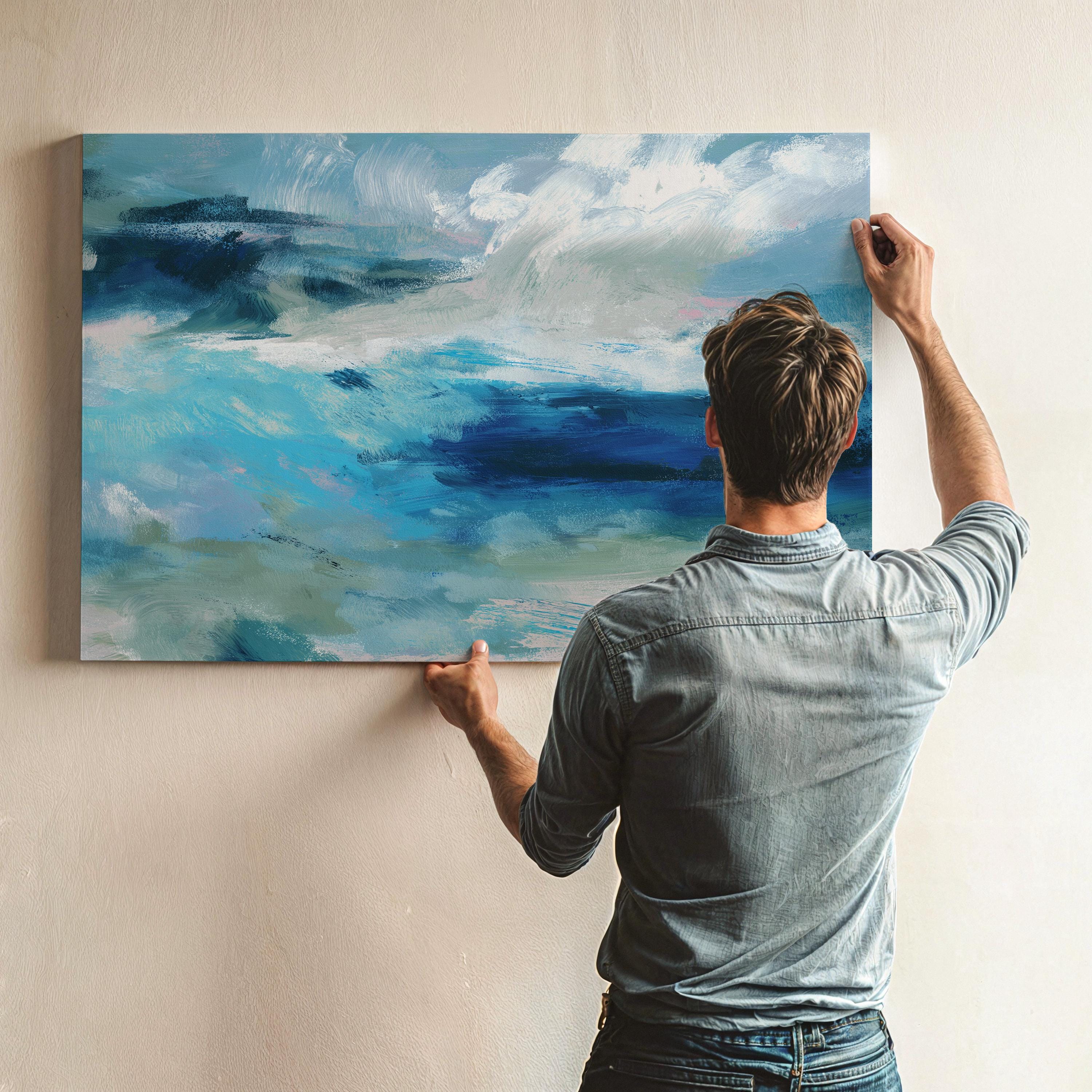 Horizontal coastal canvas wall art featuring layered strokes of ocean blue, sage green, and soft white in an abstract seascape style. Designed for serene, nature-inspired interiors like beach houses, living rooms, and entryways. Available as a fine art poster or canvas wall art for curated, color-forward decor.