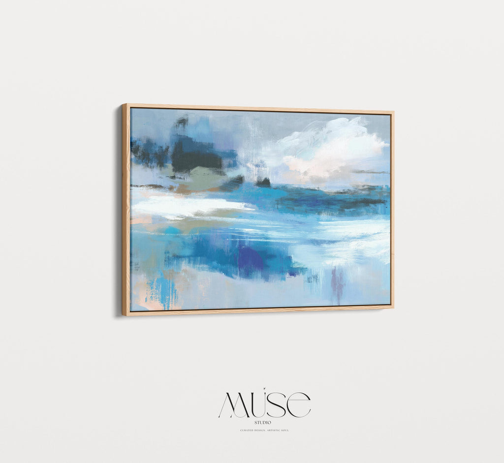 Framed horizontal wall art featuring soft painterly layers of ocean blue, sand beige, and sky tones in a modern coastal abstract. Ideal for beach house living rooms, transitional interiors, or above sofa placement. Available as a fine art poster or canvas wall art for curated, color-forward decor.