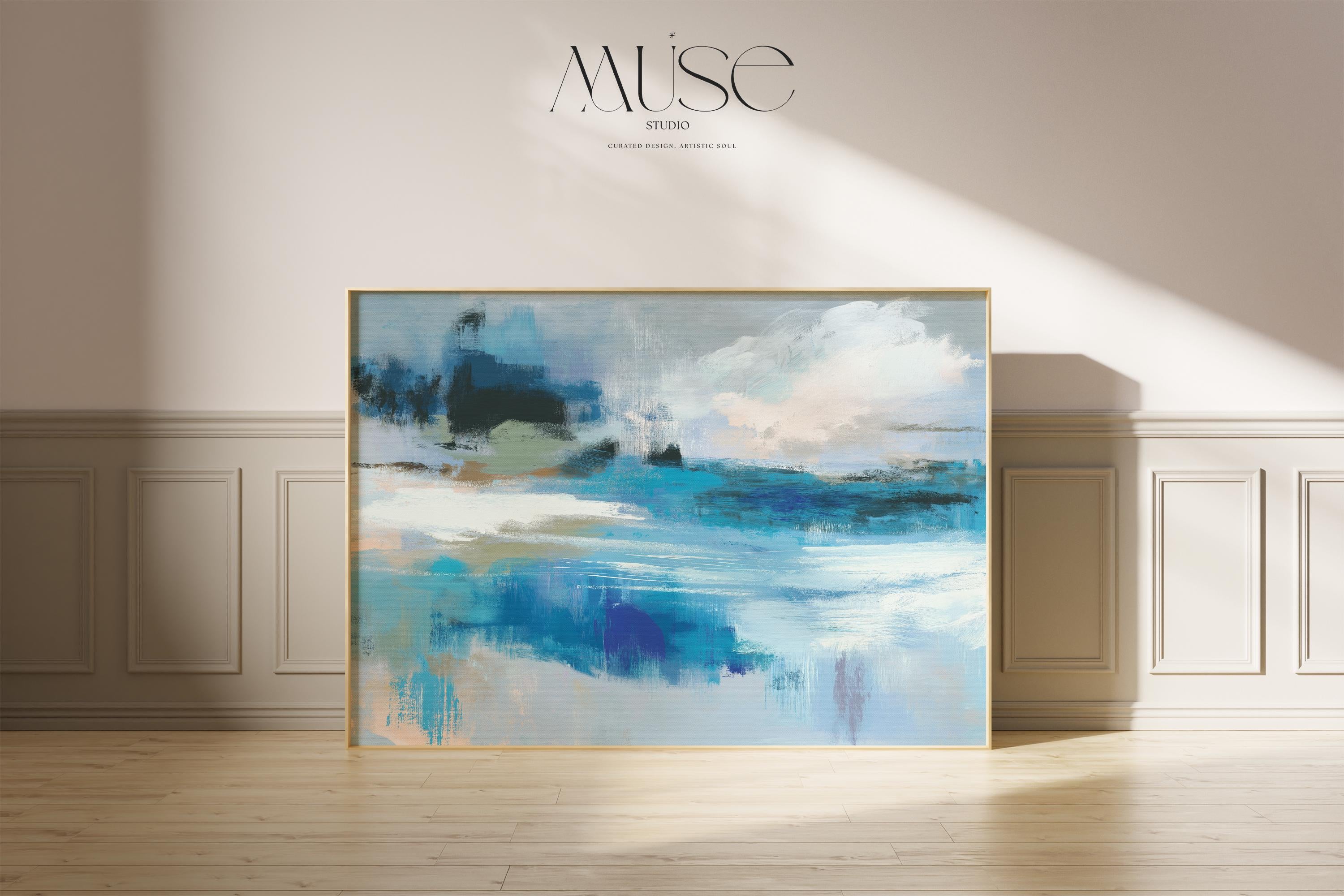 Oversized blue coastal abstract wall art with soft white clouds and ocean-inspired brushstrokes, leaning against paneled walls in a sunlit room. Muted coastal horizon artwork available as framed wall art, canvas, or fine art print by Muse Studio.