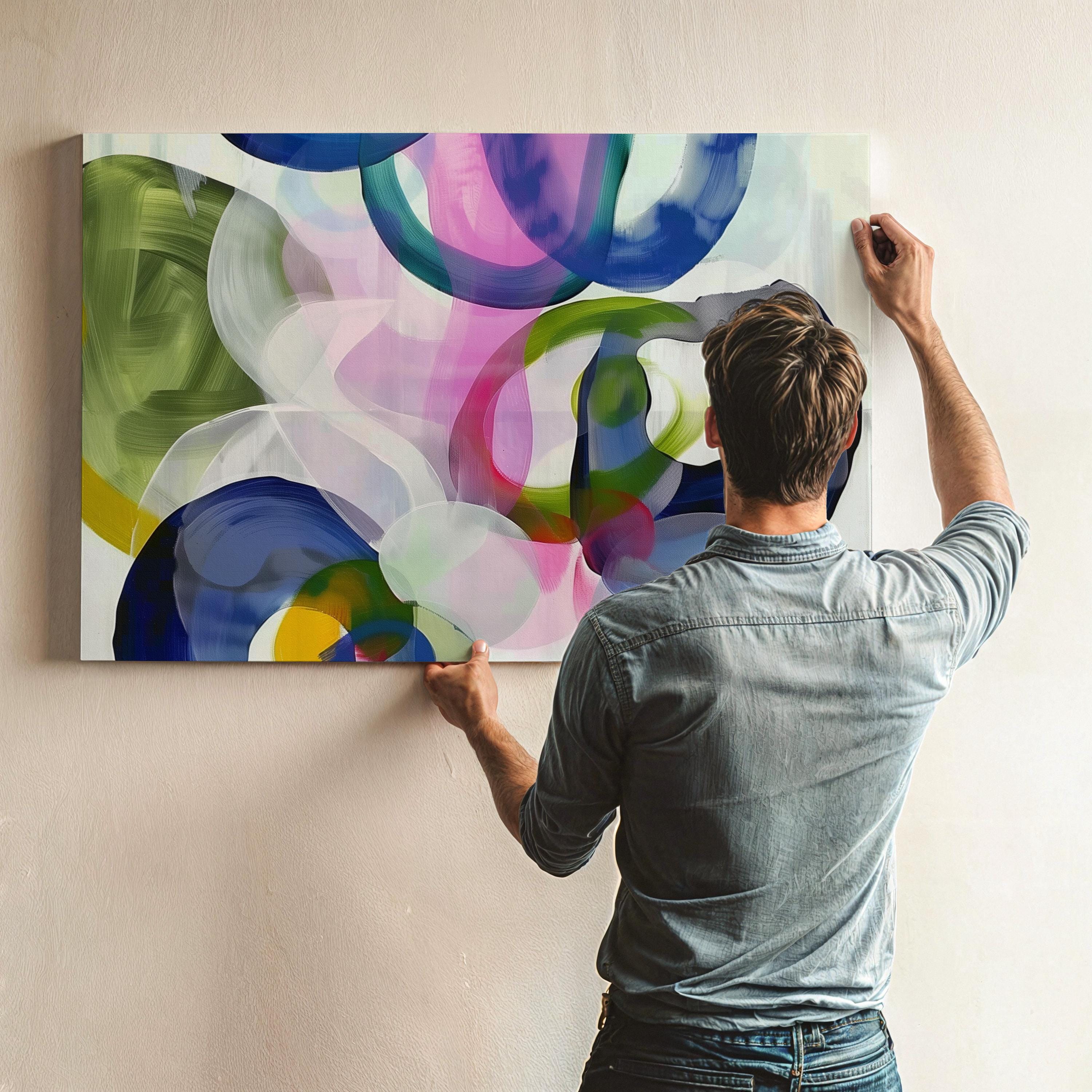 Colorful abstract canvas art featuring layered translucent brushstrokes in olive green, cobalt blue, rose pink, and deep black on a light background. The playful overlapping circles and bold movement make this piece ideal for eclectic interiors or vibrant living rooms. Available as a fine art poster or canvas wall art for curated, color-forward decor.