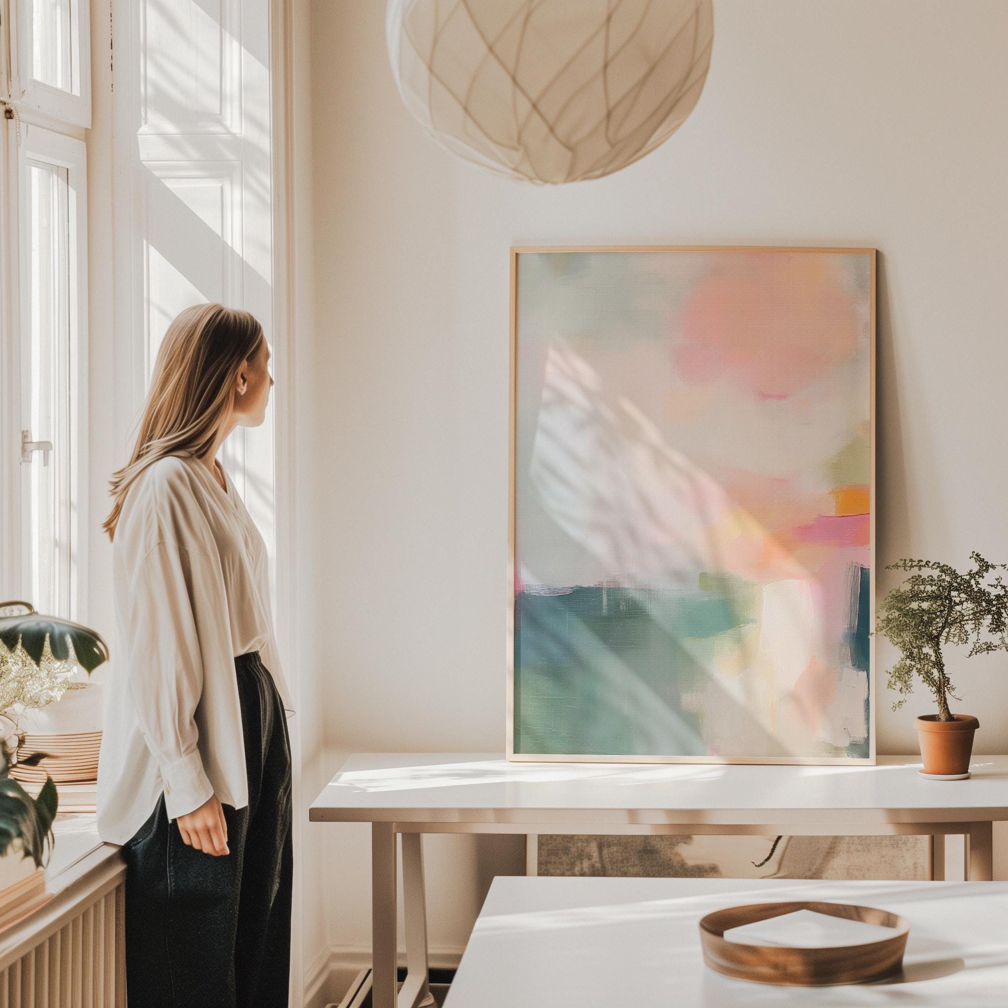 Vertical giclée art print in soft pastels featuring abstract brushstrokes in blush, sage, peach, and teal. Styled in a minimalist setting, this fine art poster brings calm and modern elegance to bedroom or entryway spaces. Available as a fine art poster or canvas wall art for curated, color-forward decor.