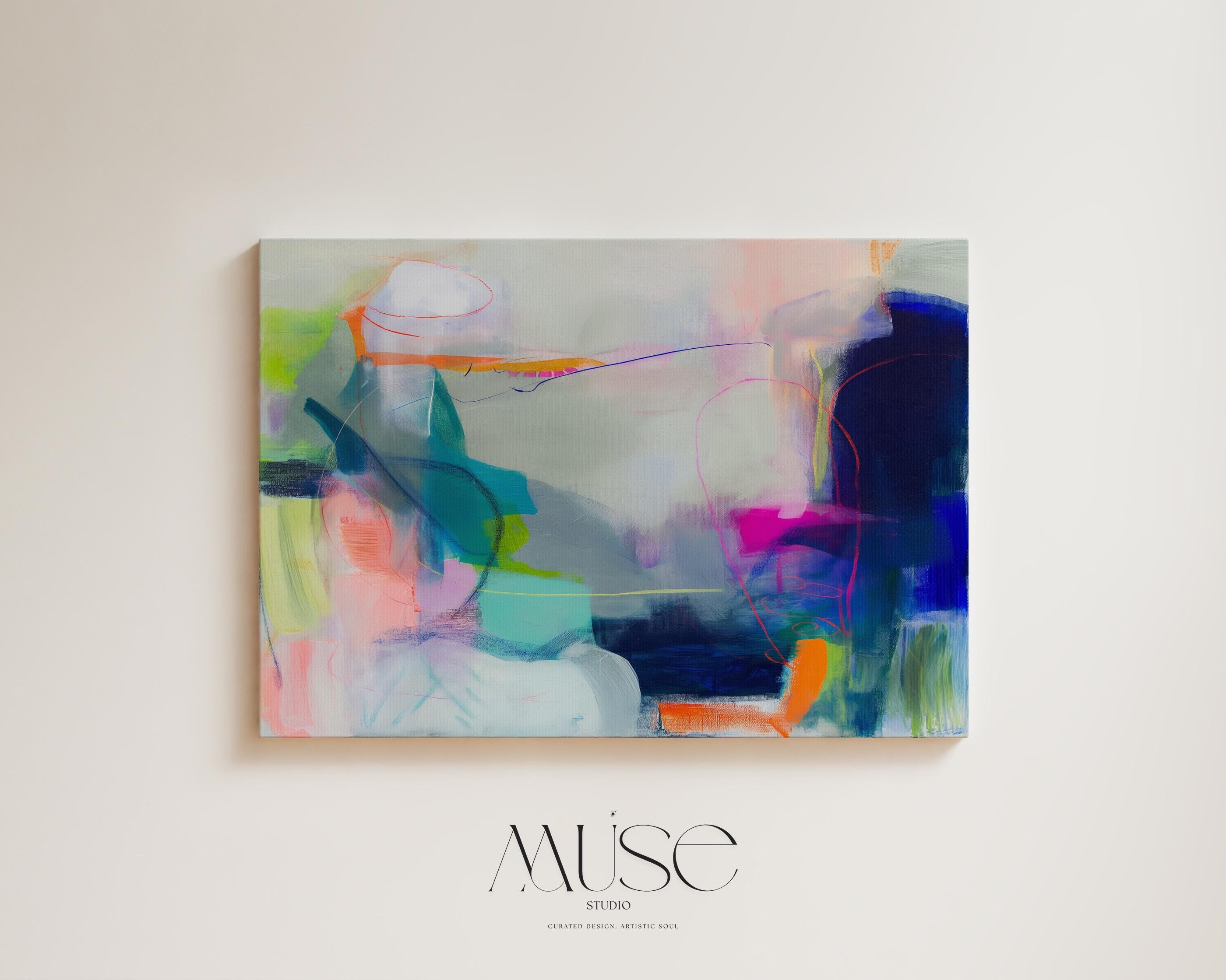Large horizontal abstract wall art in bright blue, neon pink, teal, and multicolor tones displayed above a white sofa in a modern neutral living room with natural light and minimal decor. Vibrant color pop artwork available as framed canvas or fine art print by Muse Studio.