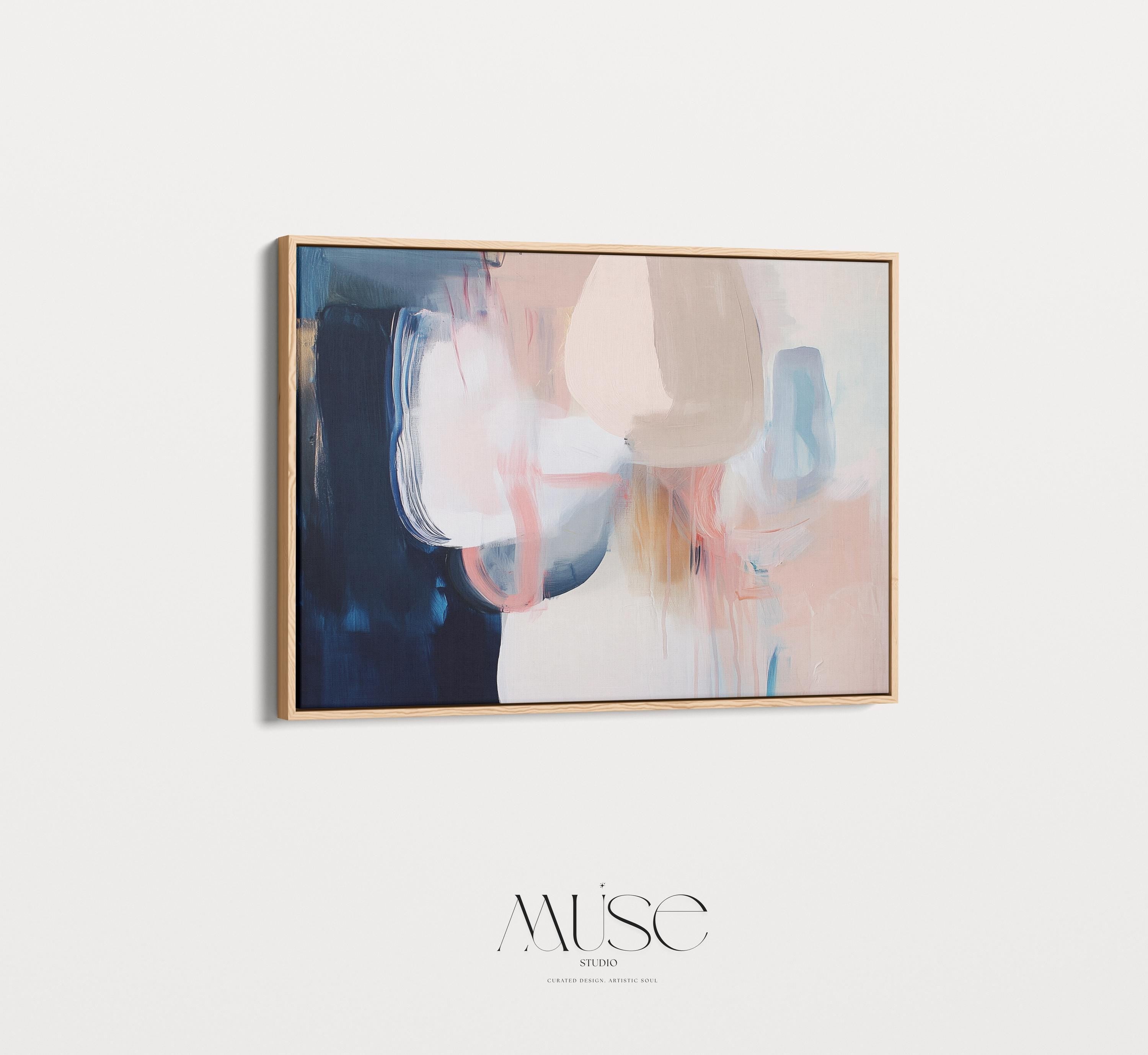 Large framed canvas wall art featuring blush, peach, ivory, muted blue, and navy tones in a horizontal abstract giclée print. Designed in muted neutral style with transitional and soft contemporary appeal, this artwork is perfect for living rooms, dining rooms, or bedrooms. Its calming palette and painterly textures bring balance and elegance to interiors. Available as a floating framed canvas giclée print in multiple large sizes.