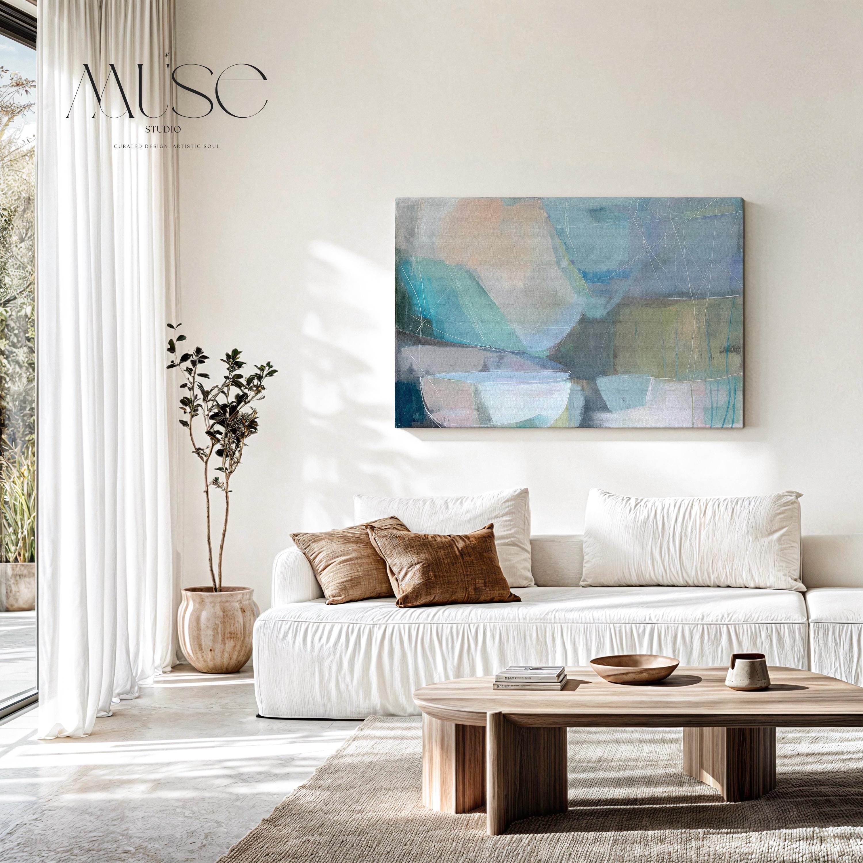 Horizontal abstract wall art in soft blue, aqua, and muted neutral tones displayed on a sunlit wall. Large modern canvas painting with pastel contemporary brushwork, ideal for living room, bedroom, or designer interior spaces. Available as a large canvas wall art print by Muse Studio.