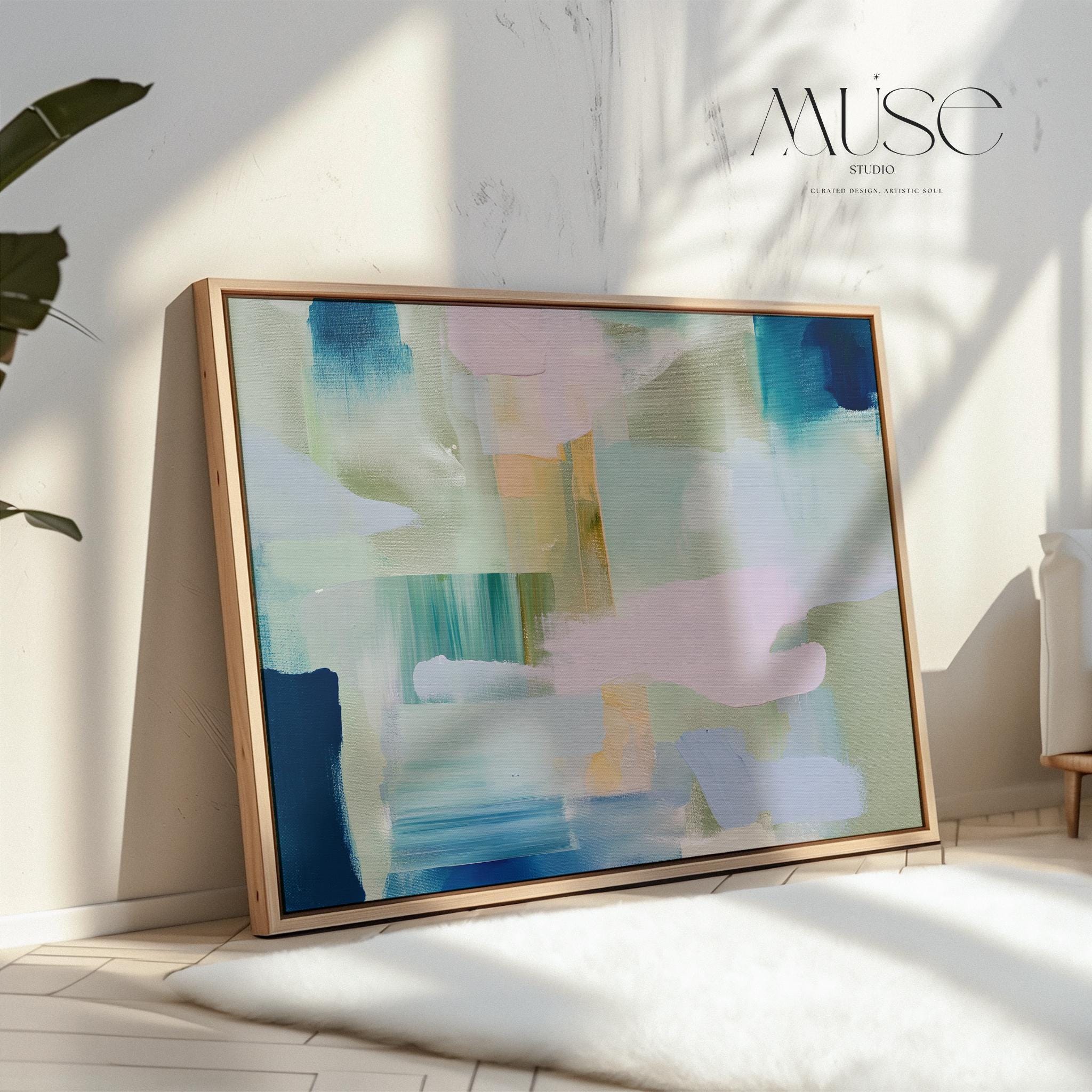 Framed horizontal abstract wall art in coastal blue, sage green, and blush pink, painted with soft layered brushstrokes. A muted modern piece that fits perfectly above sofas, beds, or long entryway walls. Premium floating wood frame for a polished finish. Available as large framed canvas wall art by Muse Studio.