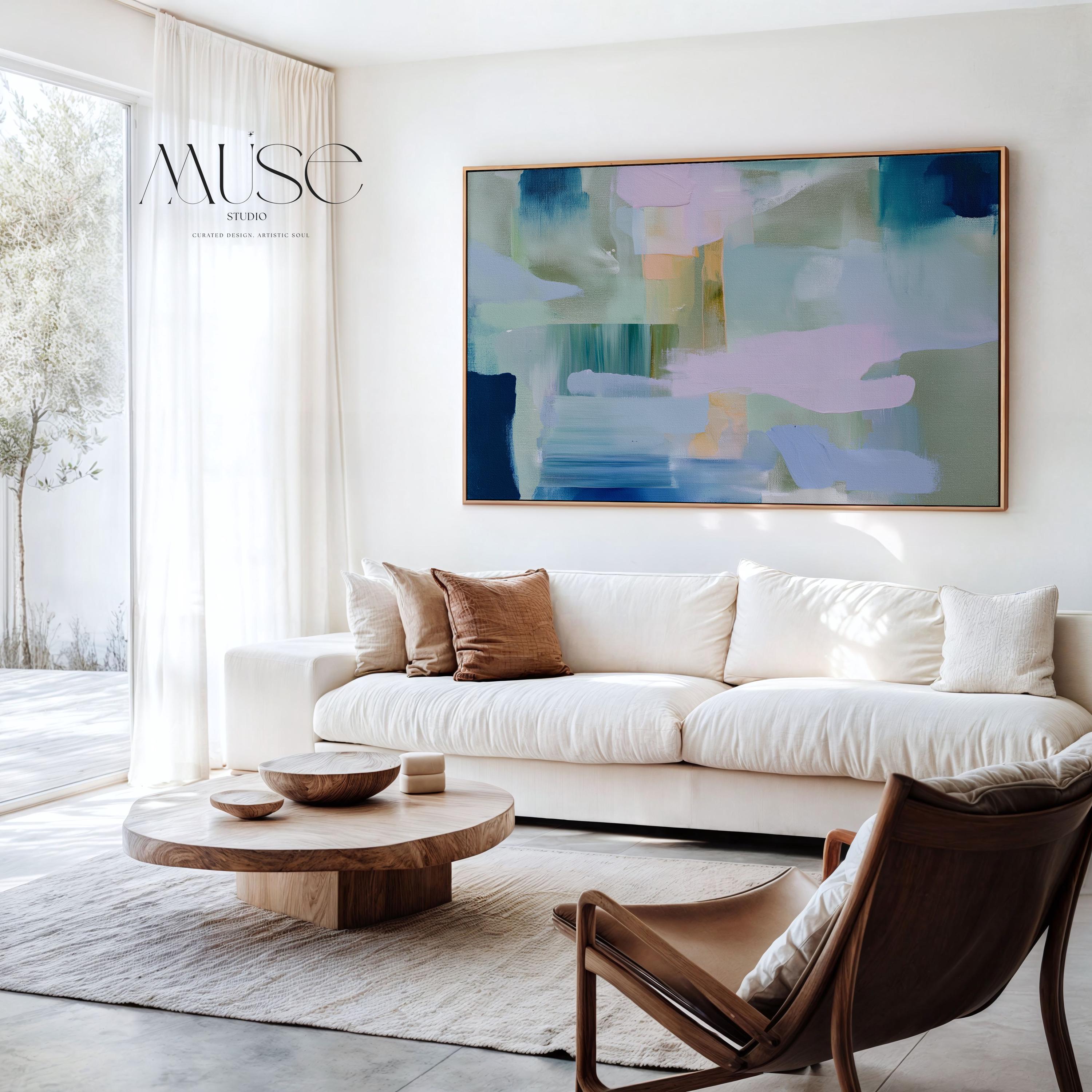 Framed horizontal abstract wall art in coastal blue, sage green, and blush pink, painted with soft layered brushstrokes. A muted modern piece that fits perfectly above sofas, beds, or long entryway walls. Premium floating wood frame for a polished finish. Available as large framed canvas wall art by Muse Studio.
