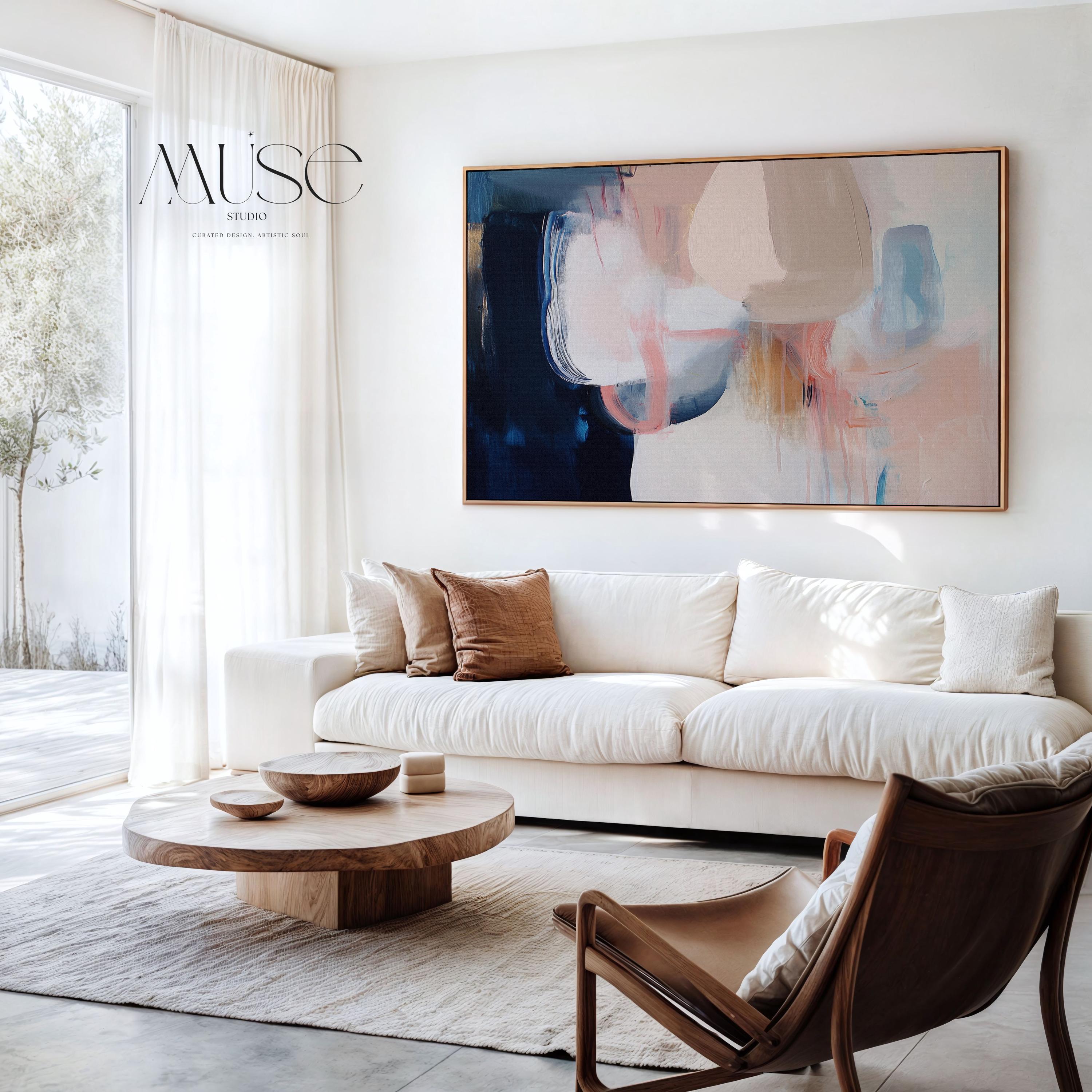 Large framed canvas wall art featuring blush, peach, ivory, muted blue, and navy tones in a horizontal abstract giclée print. Designed in muted neutral style with transitional and soft contemporary appeal, this artwork is perfect for living rooms, dining rooms, or bedrooms. Its calming palette and painterly textures bring balance and elegance to interiors. Available as a floating framed canvas giclée print in multiple large sizes.