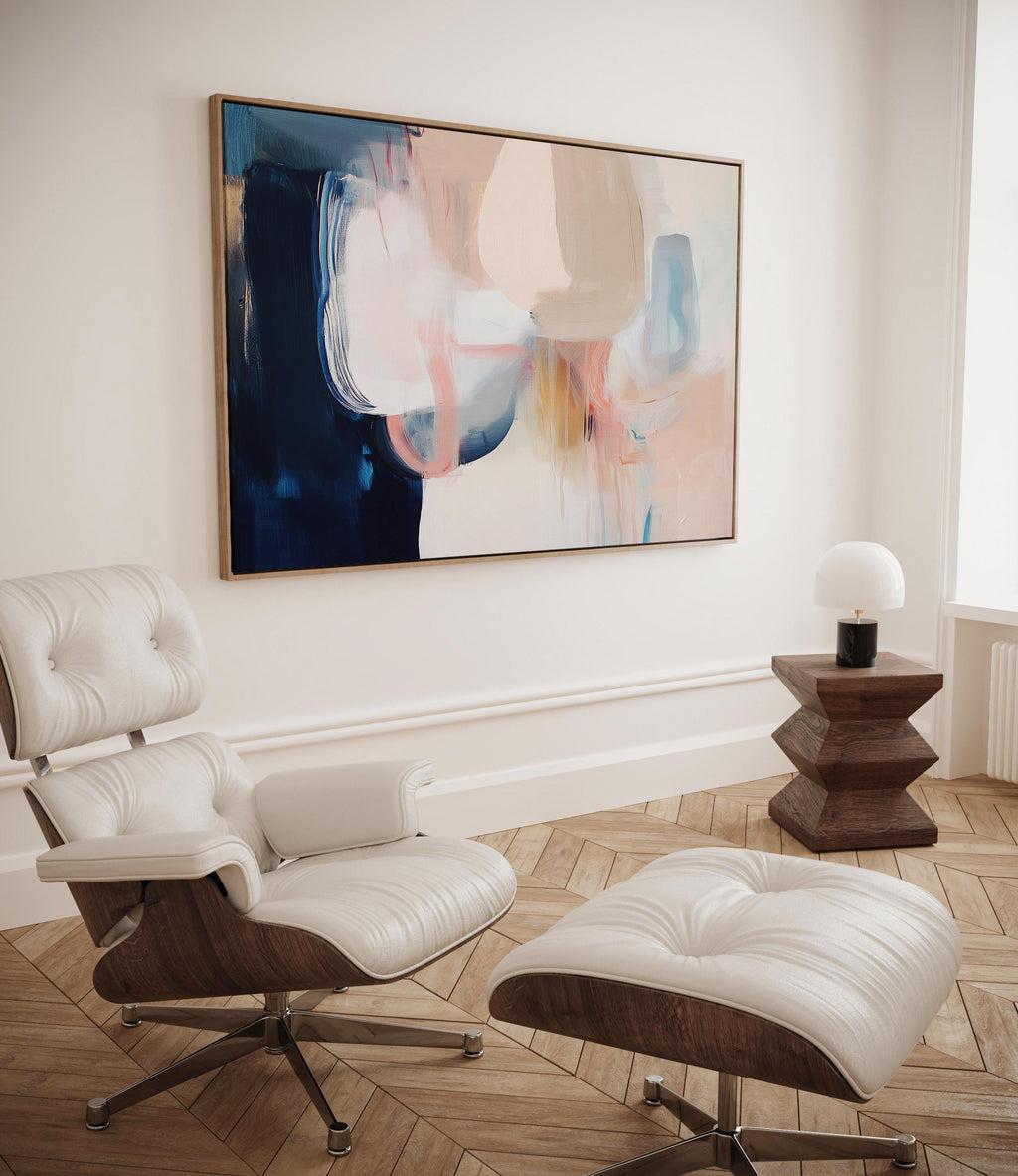 Large framed canvas wall art featuring blush, peach, ivory, muted blue, and navy tones in a horizontal abstract giclée print. Designed in muted neutral style with transitional and soft contemporary appeal, this artwork is perfect for living rooms, dining rooms, or bedrooms. Its calming palette and painterly textures bring balance and elegance to interiors. Available as a floating framed canvas giclée print in multiple large sizes.
