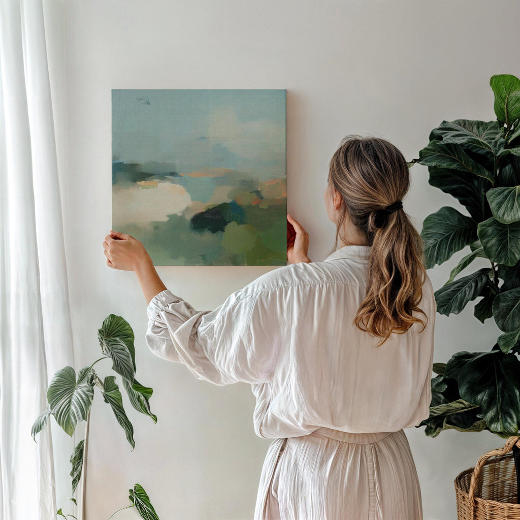 Square abstract wall art in soft greens, muted blues, and earthy tones with a horizon-inspired design. Large canvas artwork styled for modern interiors, perfect for living rooms, bedrooms, or entryways. A calming, nature-inspired piece that complements soft contemporary, coastal, and warm minimalist decor. Available as gallery-wrapped canvas, framed canvas, or fine art print.