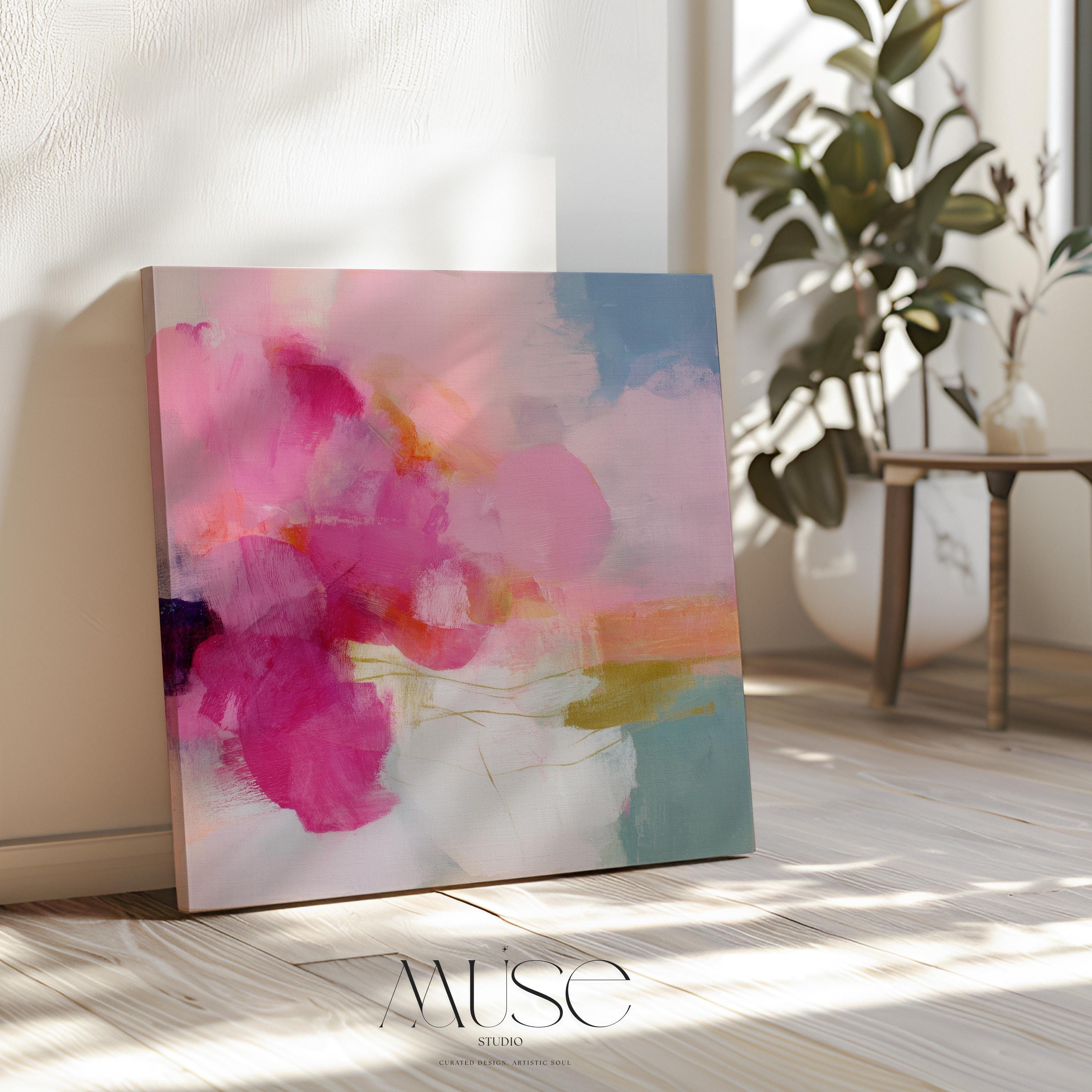 Square abstract canvas wall art featuring vivid pink, coral, and golden brushstrokes against a soft backdrop. Bold yet refined, this statement artwork suits transitional, boho, and soft contemporary interiors. Perfect for bedrooms, living rooms, or entryway decor. Available as framed or gallery-wrapped canvas.